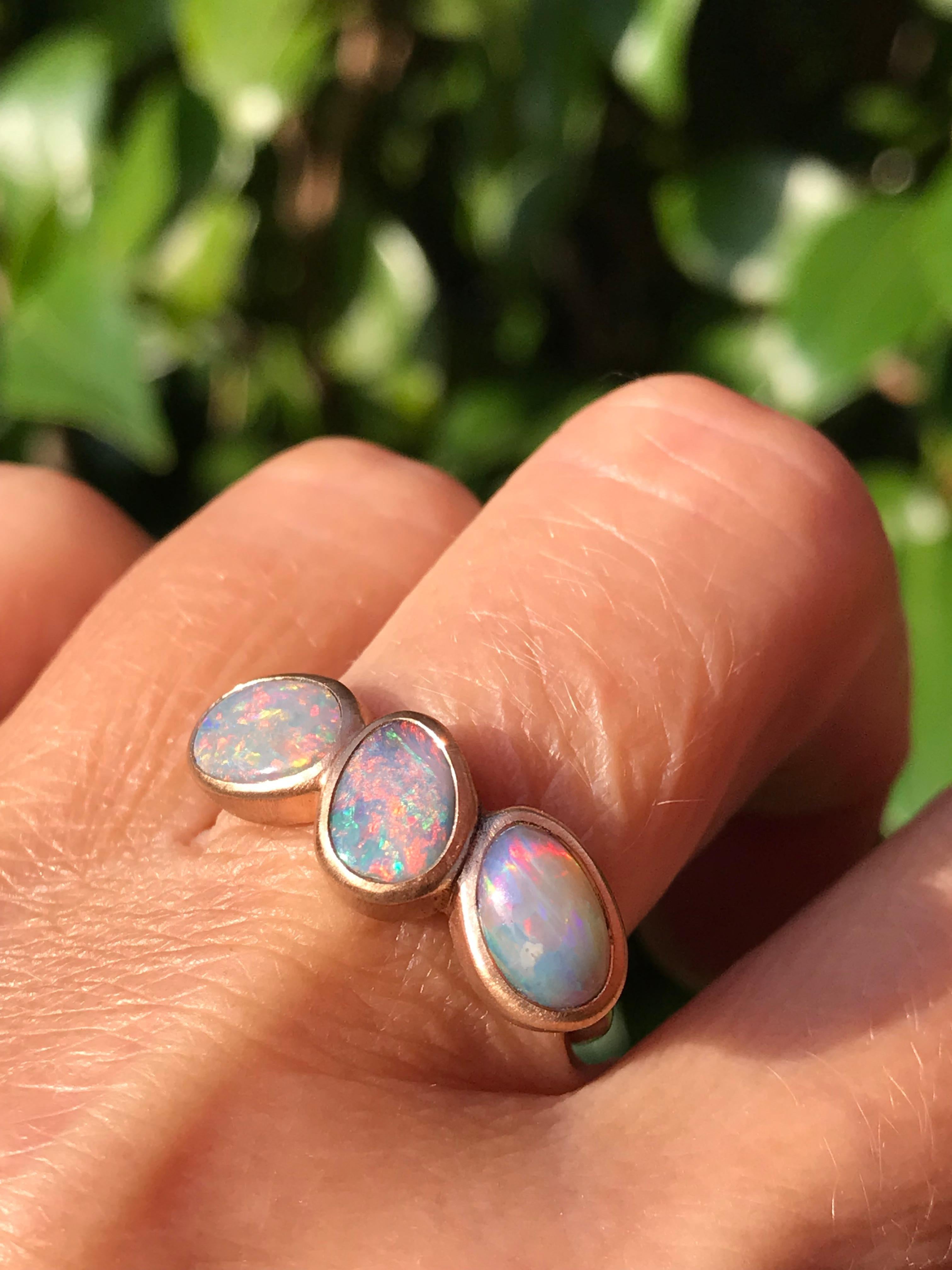Dalben design One of a kind 18 kt rose  gold ring with three bezel-set pink - blue Australian Crystal Opals weight 2,8 carats  .  
Ring size  US 7 1/4  - EU 55 re-sizable .  
Bezels setting dimension:  
max width 23,4 mm,  
max height 8,6 mm. 
The