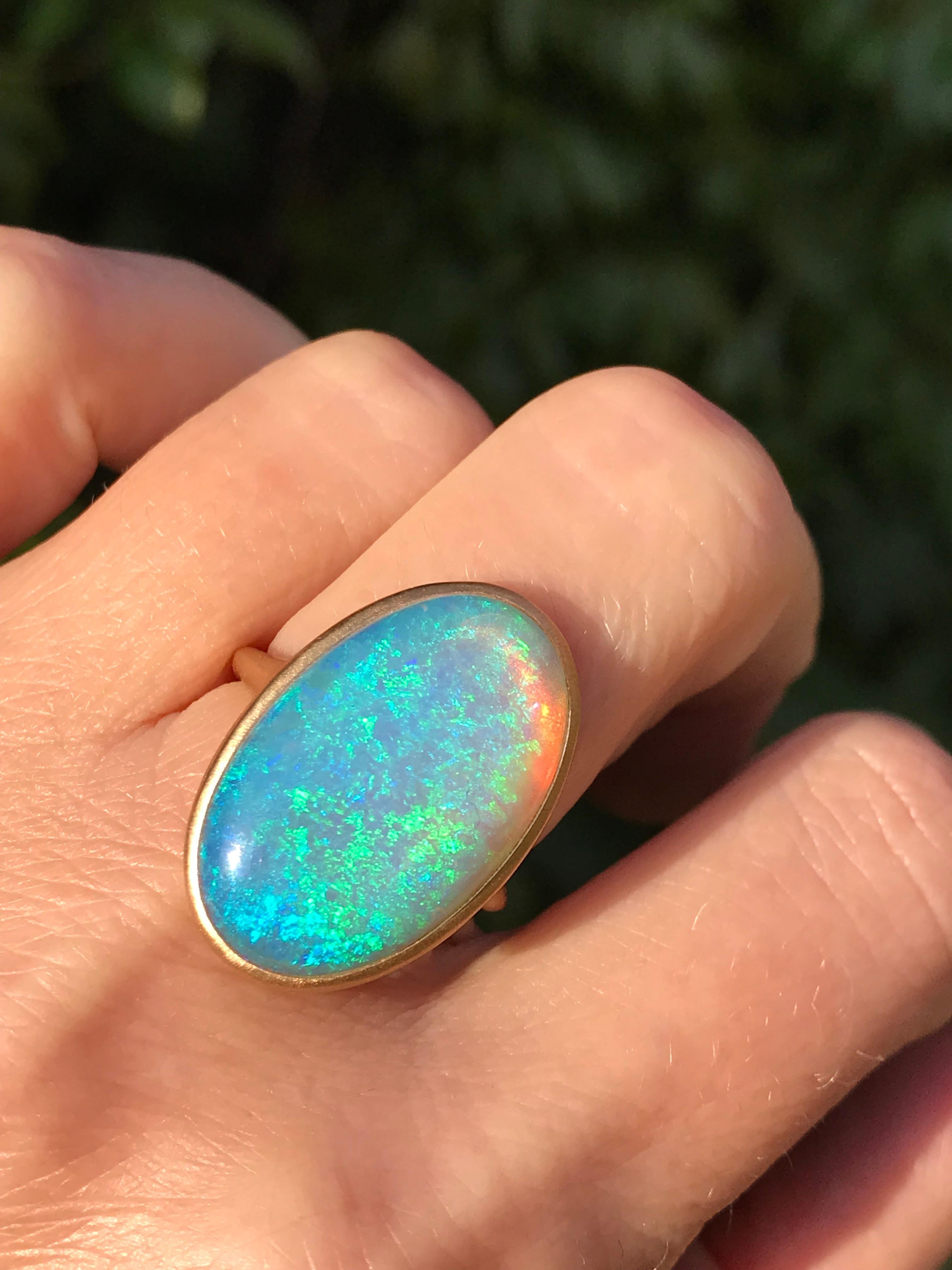 Dalben design One of a kind 18 kt yellow  gold ring with a magnificent oval cabochon solid Australian Crystal Opal weight 9,94 carats from Coober Pedy mines area .
The opal has  wonderful blue green reflex especially at sunshine 
Ring size  US 7  - 