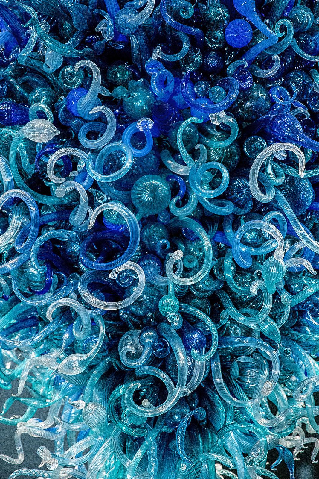 Artist: Dale Chihuly 
Description: Blue Turquoise blown glass
Medium: Hand Blown Glass Chandelier
Size: 144 x 144 in.
Studio Number: Given upon Request
Year: 2004
2000+ Glass pieces
We can help with engineering your site and also assist in lighting.