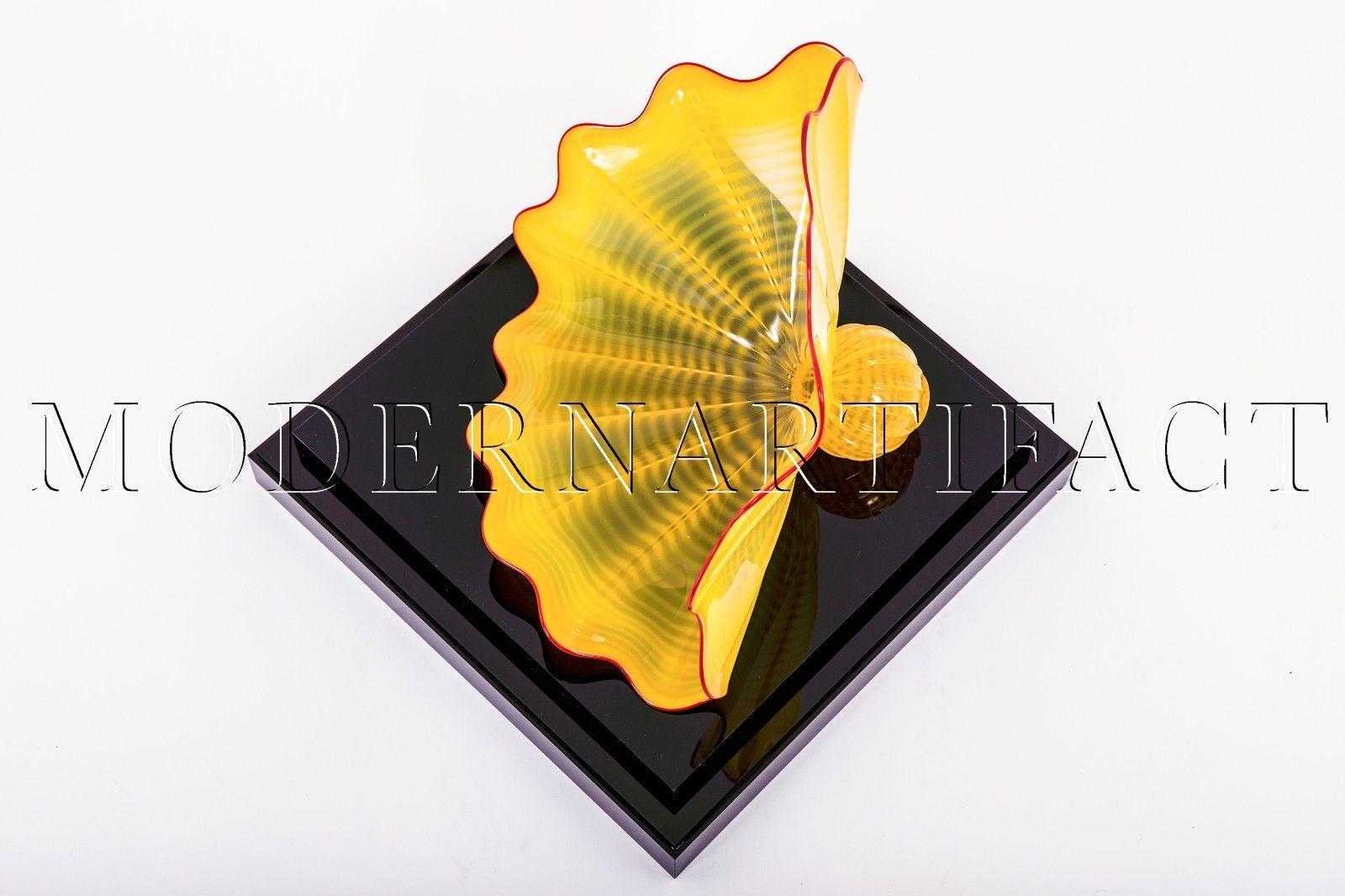 Artist: Dale Chihuly 
Title: Buttercup Yellow Persian with Blood Red Lip Warp 
Size: 9" x 13" x 10"
Year: 1996 

Series: Portland Press
Condition: Signed and dated by Chihuly in Mint condition.  Includes Acrylic Display Vitrine

Signed and dated on