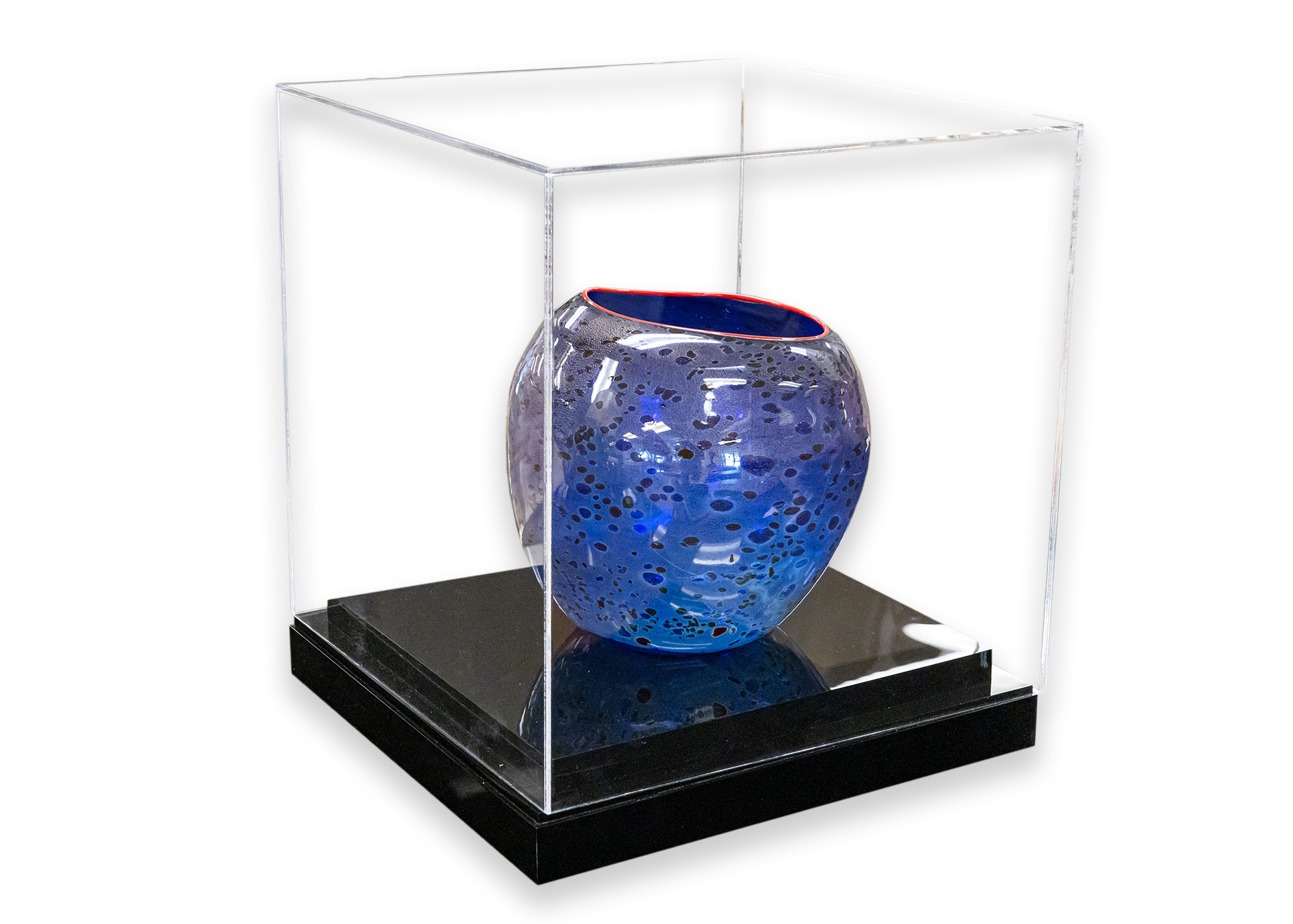 A dynamic hand-blown cobalt blue “Basket” vase by Dale Chihuly. Etched signature on underside. Published by Portland Press, 1994. A unique asymmetrical composition with oil spot decoration and cadmium red lip. For this series, Chihuly takes