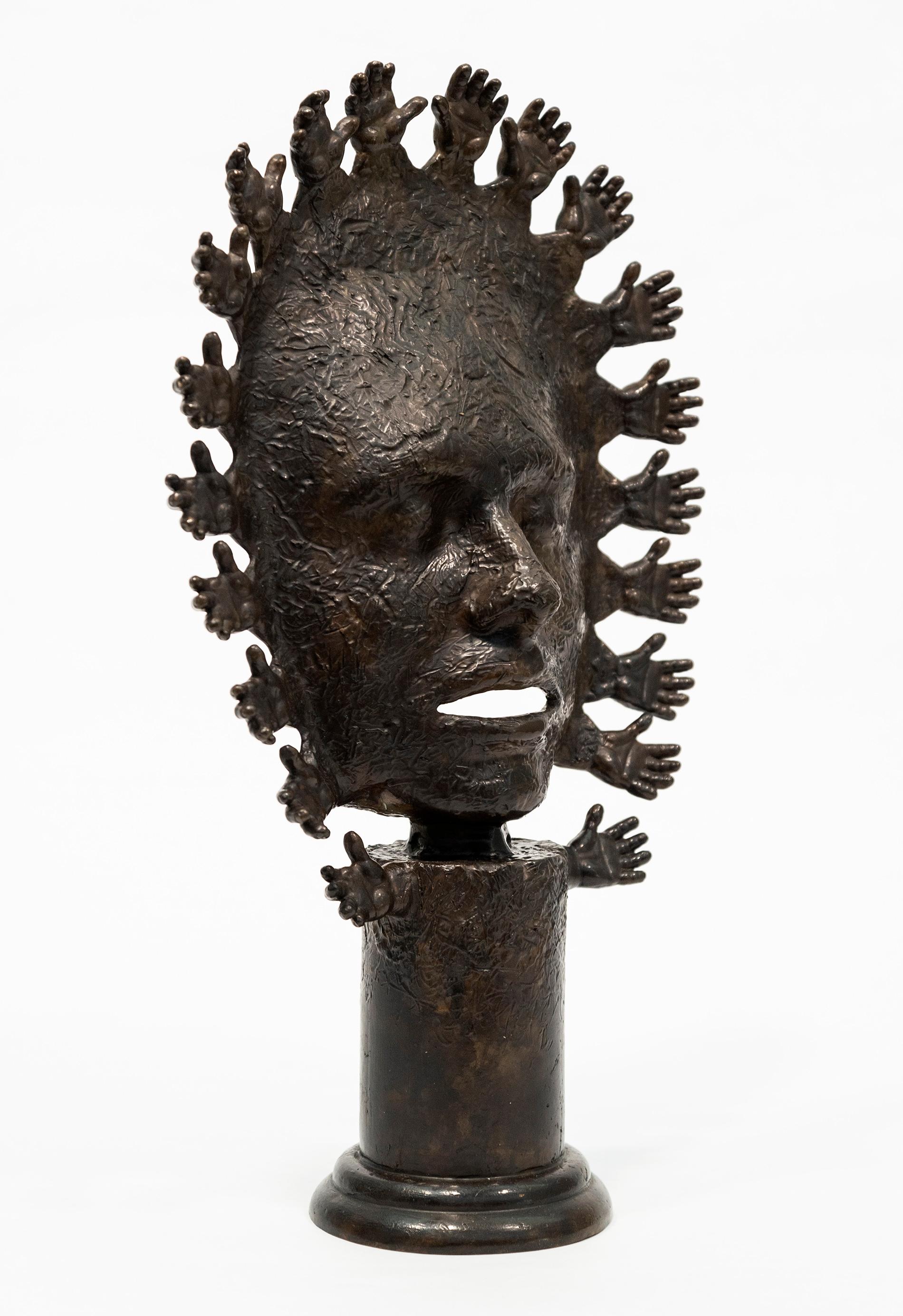 This intriguing mask cast in bronze by Dale Dunning is reminiscent in form of ancient tabletop sculptures designed as objects used in worship. Titled Benediction (meaning ‘blessing’) it features a face, eyes closed, mouth open that is framed by a