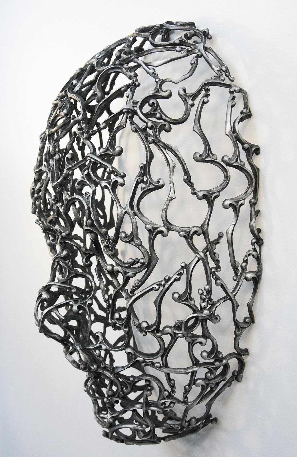 Snakes & Letters - repurposed metal, gothic, aluminum figurative wall sculpture - Beige Abstract Sculpture by Dale Dunning