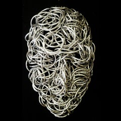 Primavera - contemporánea, figurativa, máscara, aluminio, cromo, escultura mural