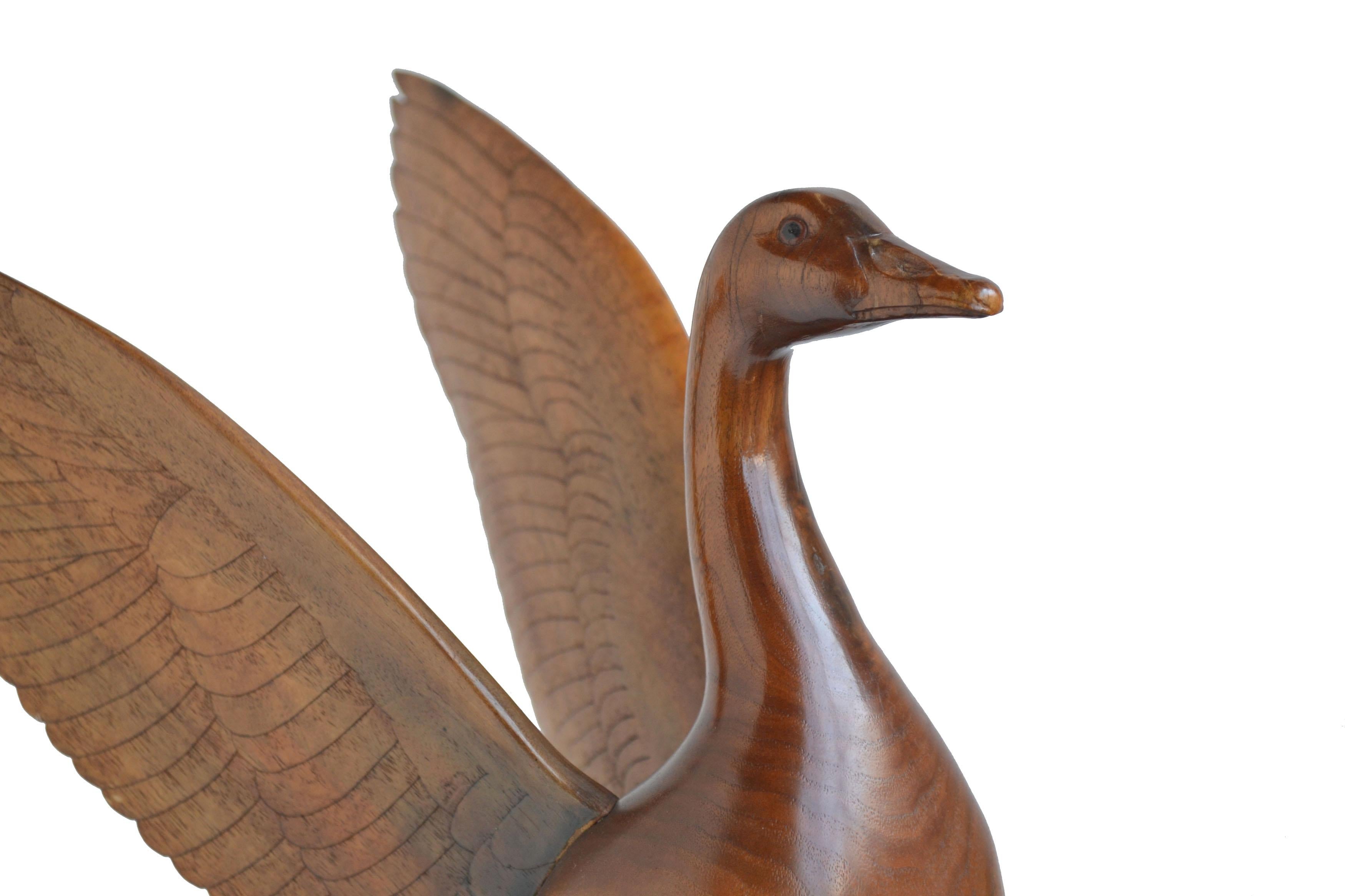 A beautiful, high polished sculpture of a goose with outstretched wings by Dale Eugene Schoth (American, 1925-1984). Appropriate to view in the round. Signed and dated by the artist 