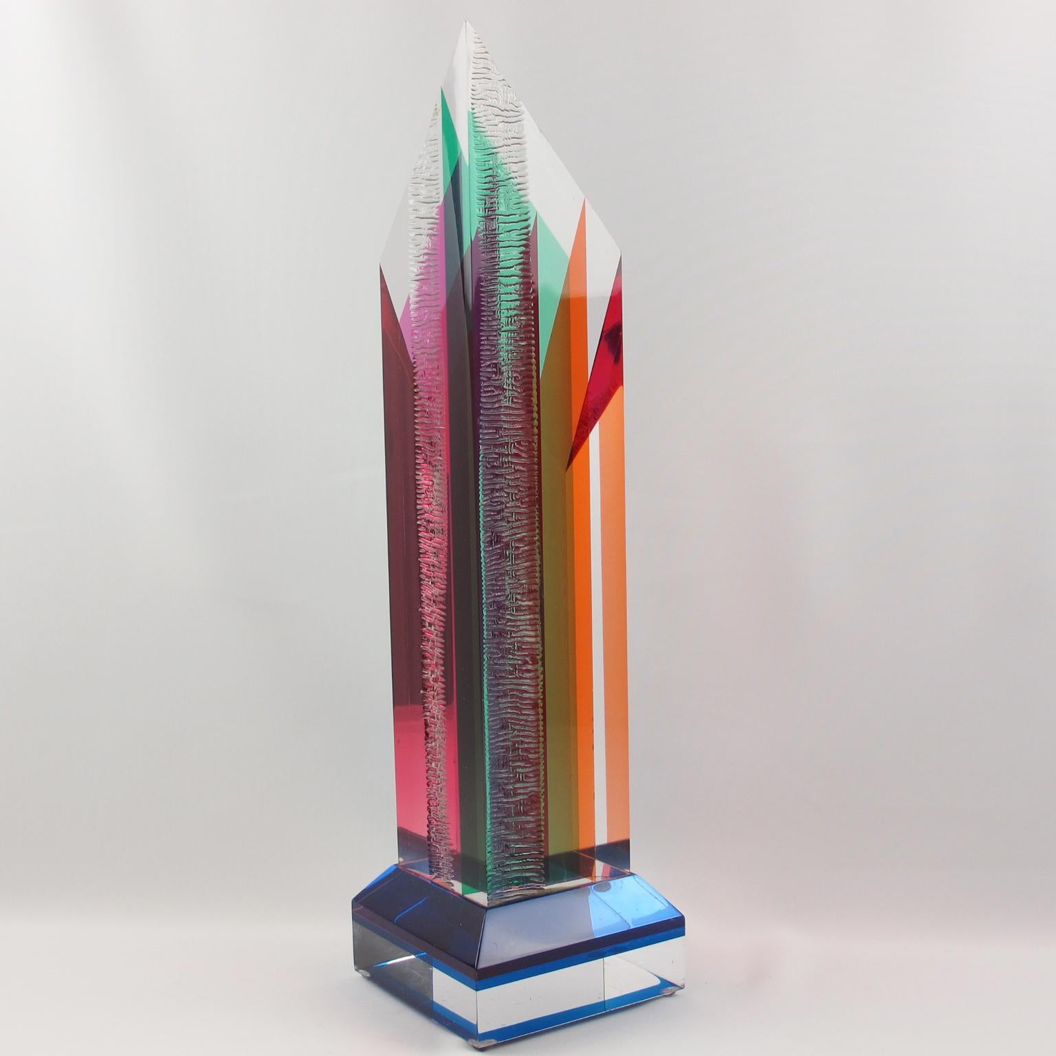 Impressive Lucite or Plexiglass sculpture or obelisk in the manner of Dale Morrow. Abstract geometrical, prismatic sculpture, colorful and interesting as lots of different optical effects are created thanks to the skyscraper shape and carving.
