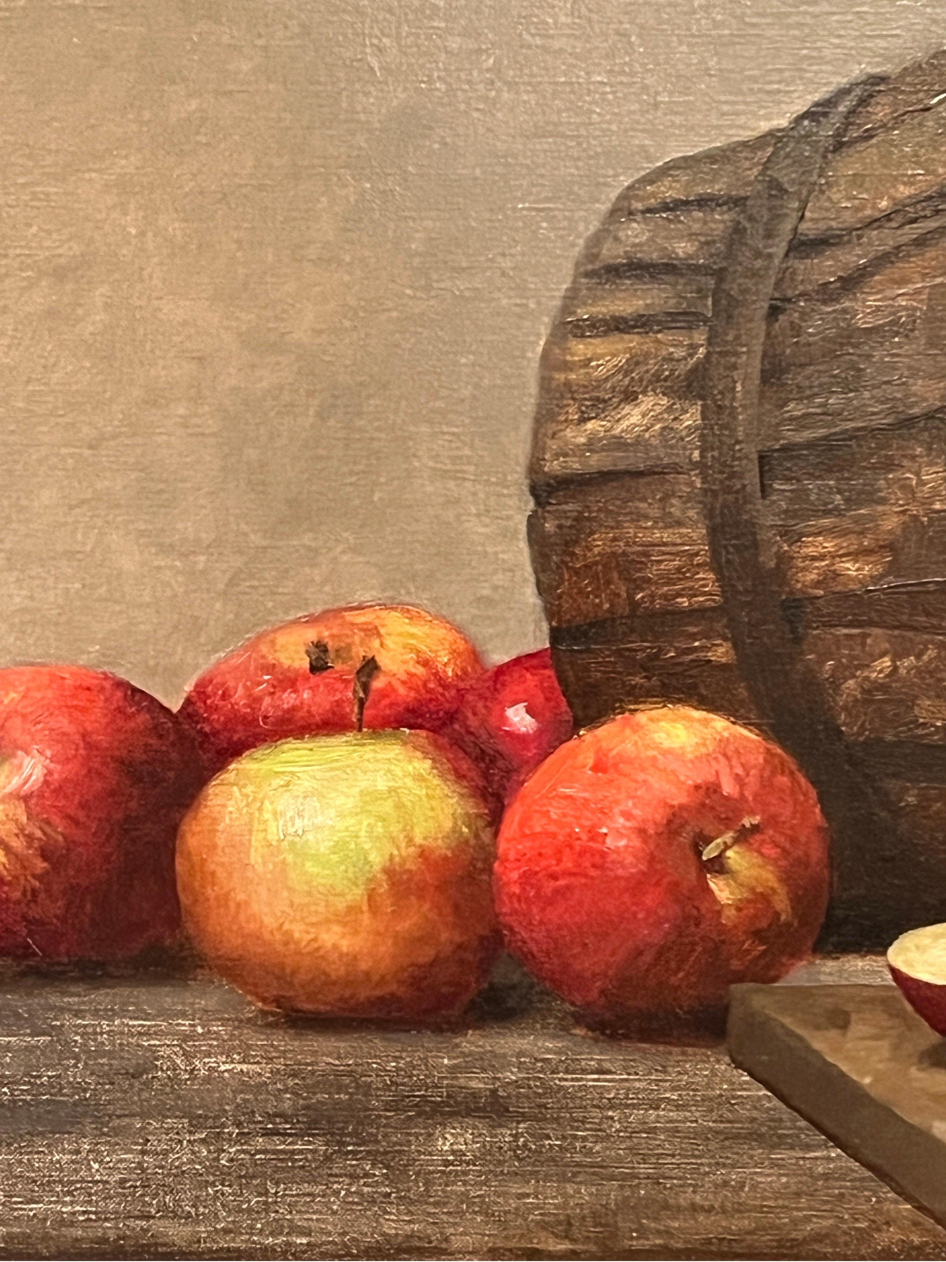 Dale Zinkowski is a master of still life. His work, reminiscent of Golden Age Dutch still life painting, glows with light and subtle, quiet beauty. This original oil painting shows a bunch of beautifully ripe apples, spilling from a rustic basket.
