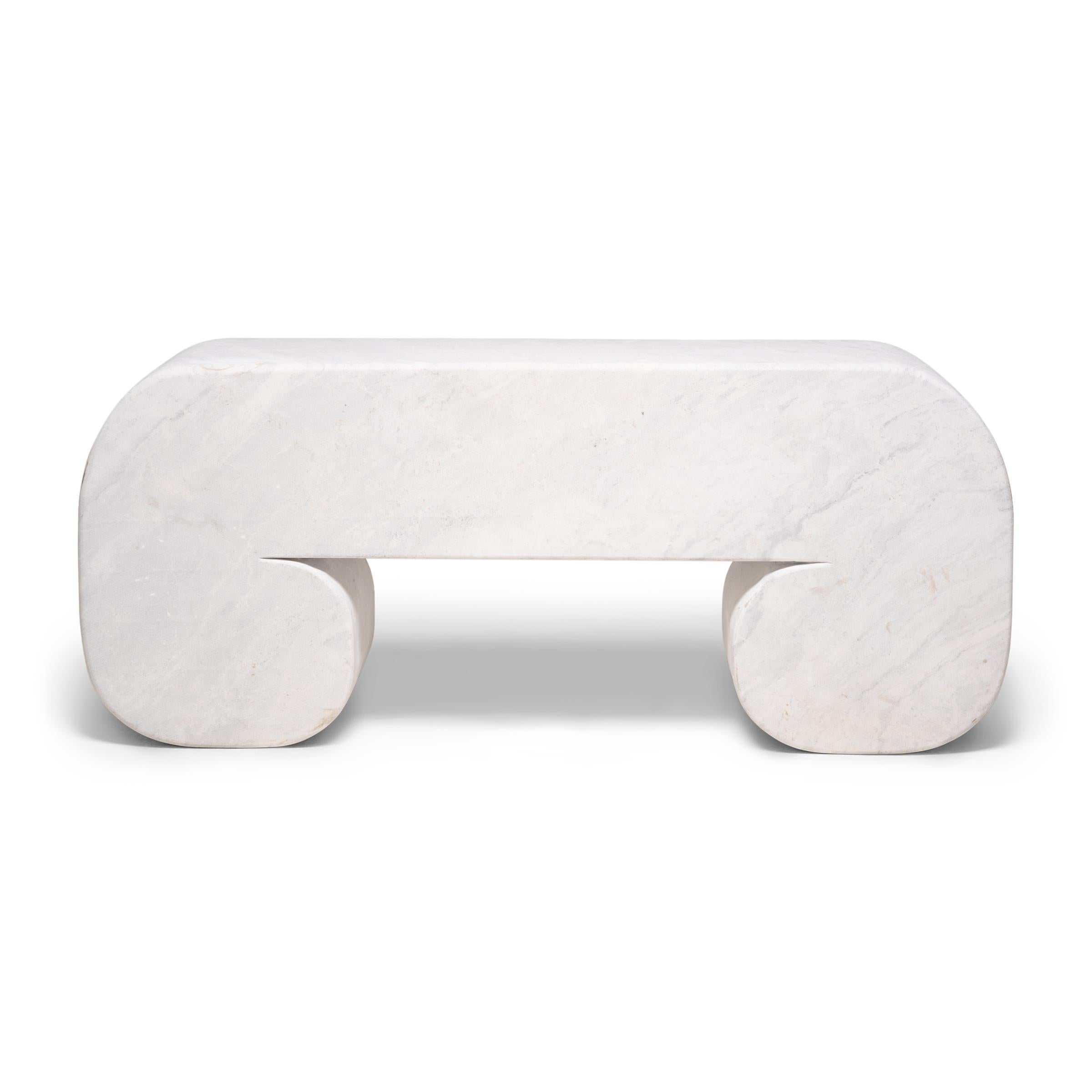 This gorgeous white marble bench is sculpted to resemble a traditional scroll table, defined by rounded corners that curve under to form cloud-like scroll feet. The minimalist bench was carved by hand from a solid block of Dali marble, an
