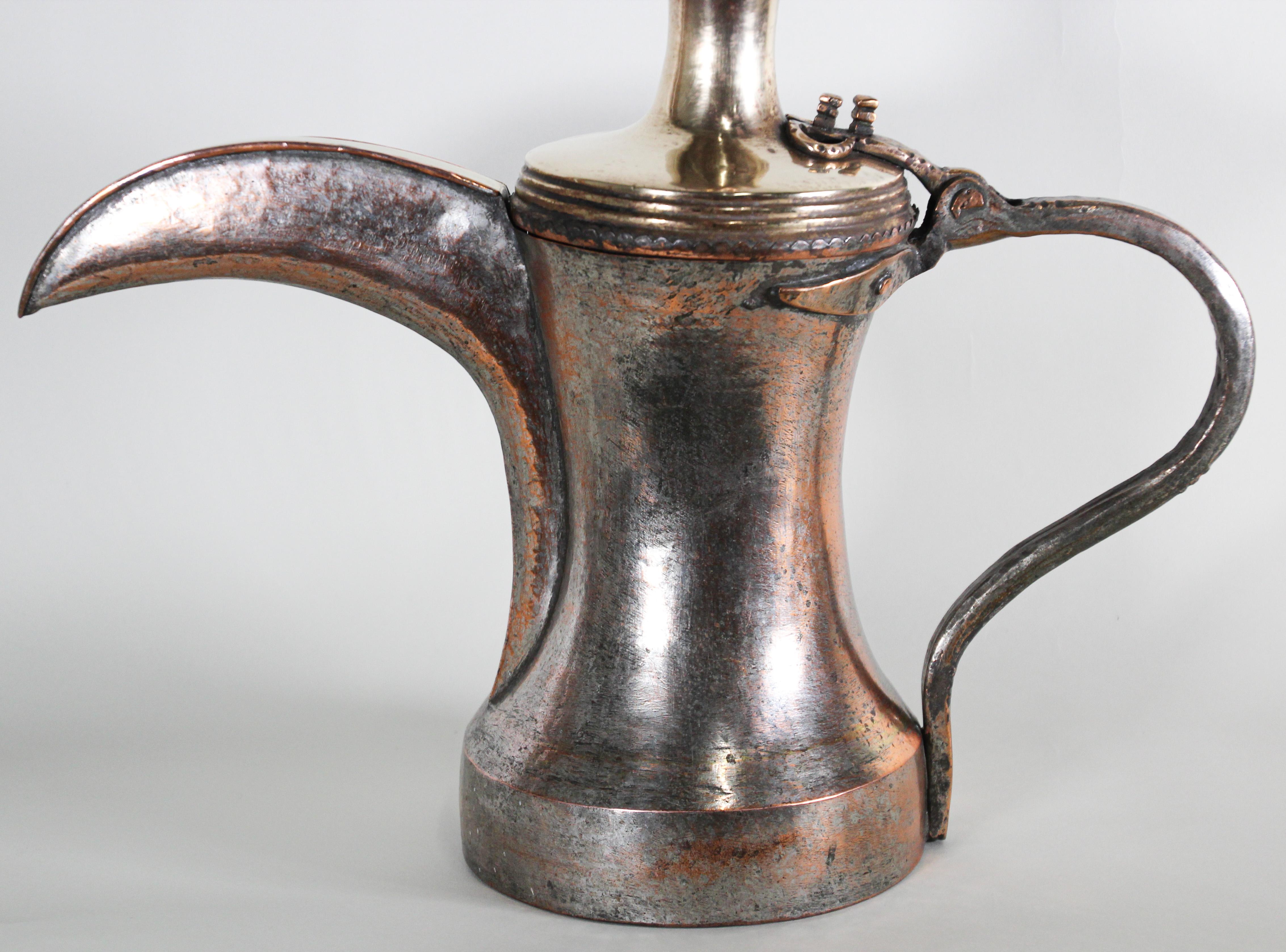 Antique 19th century Middle Eastern Dallah traditional Arabian oversized tinned copper coffee pot. 
Huge oversized decorative Arabian coffee pot hand-hammered tinned copper with riveted brass finish and a very large spout. 
Tinned copper and