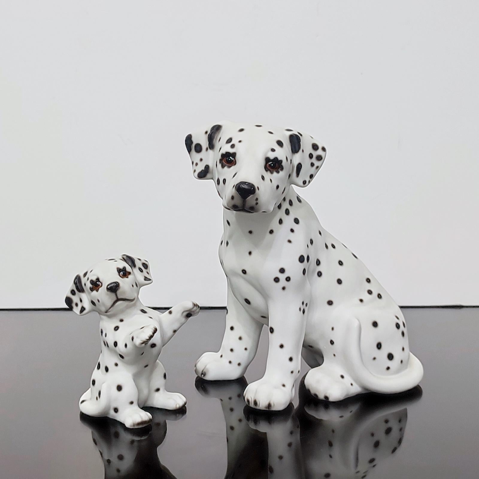 Gorgeous Dalmatian dog with its puppy, hand-painted porcelain figurines. 
Hand made and hand painted. Glass eyes. Marked on the bottom with maker's mark and impressed form number.

Dimensions:
big 15 x 11 x 17.5 cm 
small 6 x 6 x 9.5 cm
Very