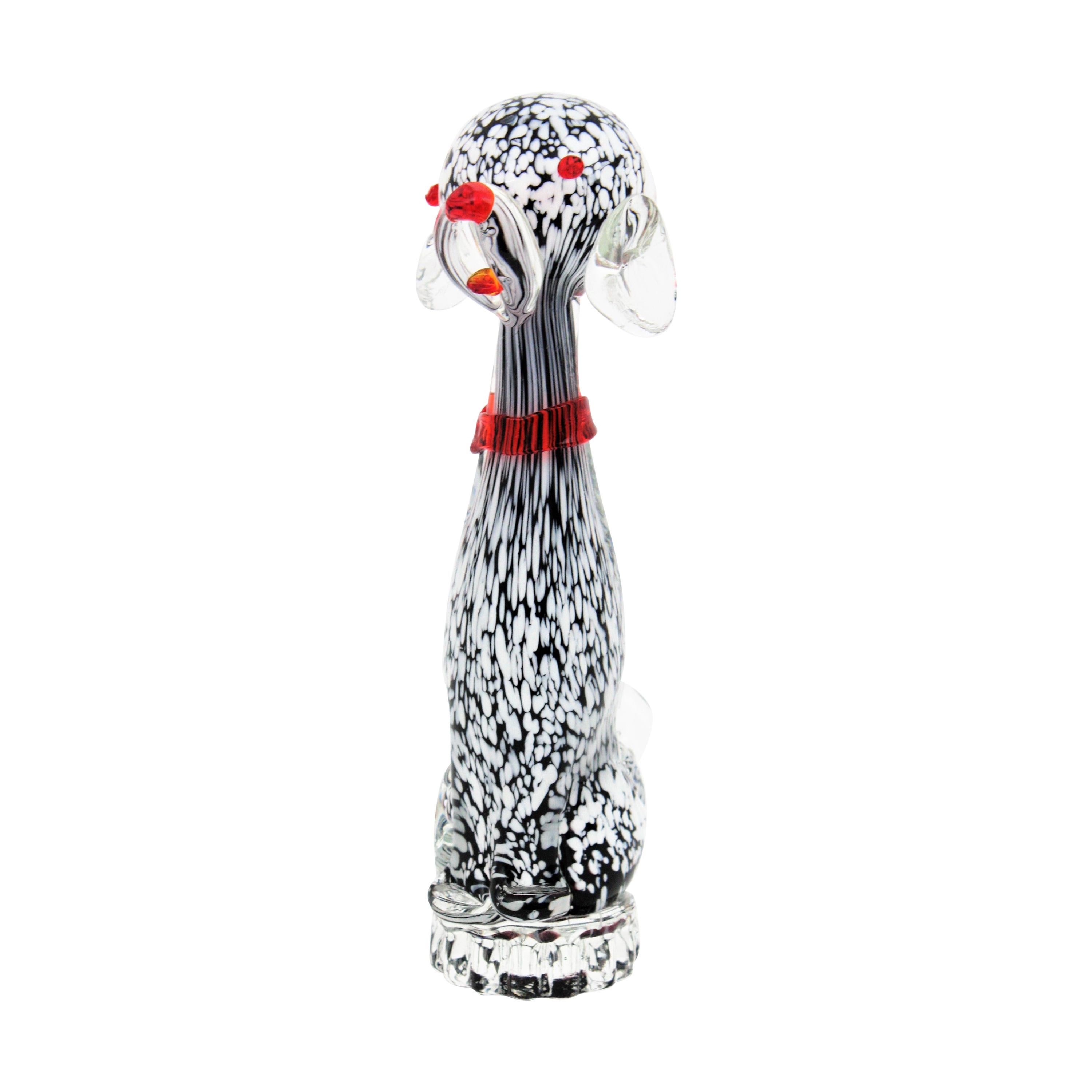 Cute hand blown Murano glass Puppy Dog Figurine Sculpture in Black and White Murrine, Italy, 1950s.
This nice doggy stands up on a small clear glass base. It has white spots on a black background and it is finished with clear glass using the