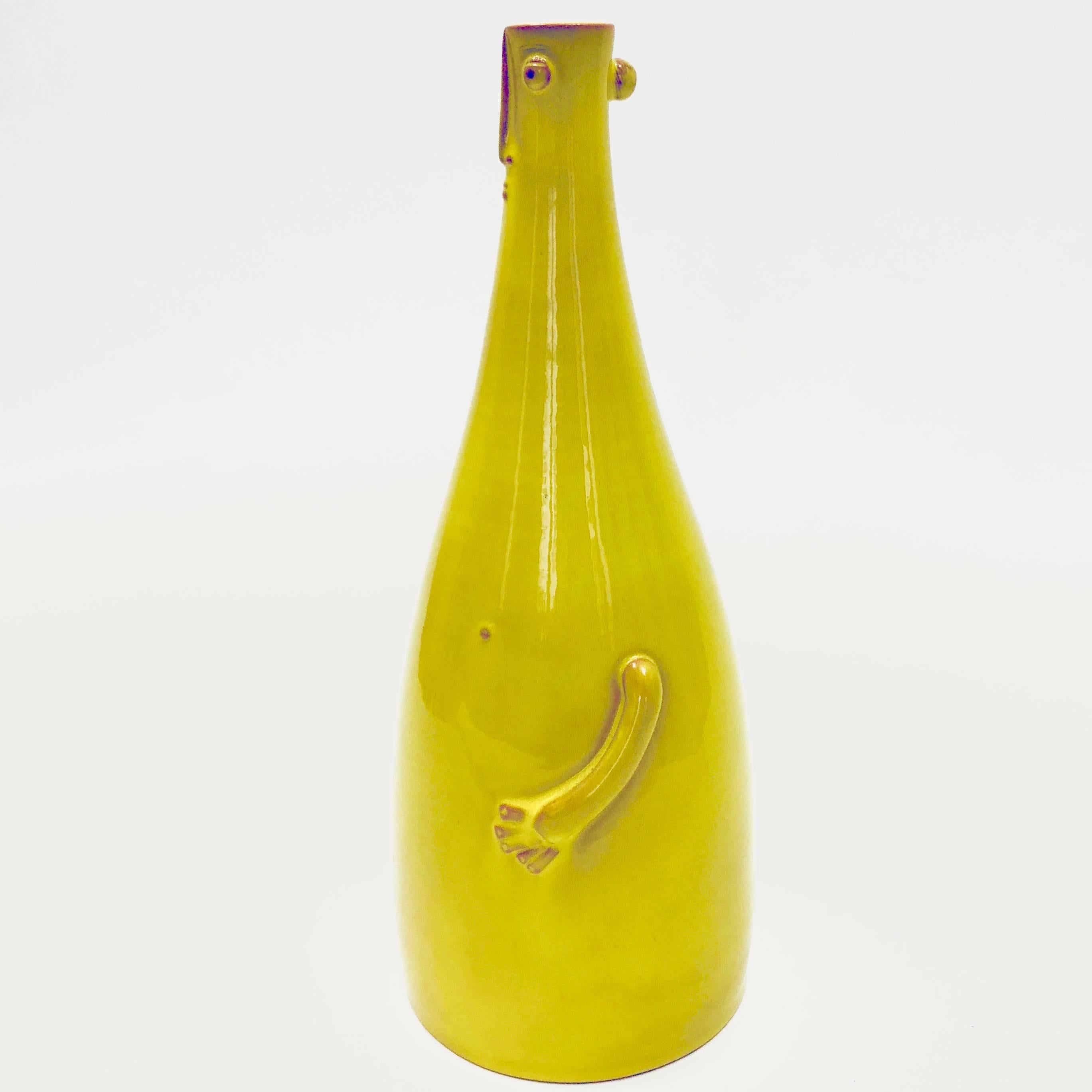 Ceramic bottle shaped vase, forming organic lamp-base, enameled in shiny yellow, decorated with character in front.

One of kind handmade pieces, signed by the French ceramicists, the Dalo.

Height measurement concerns the ceramic sculpture