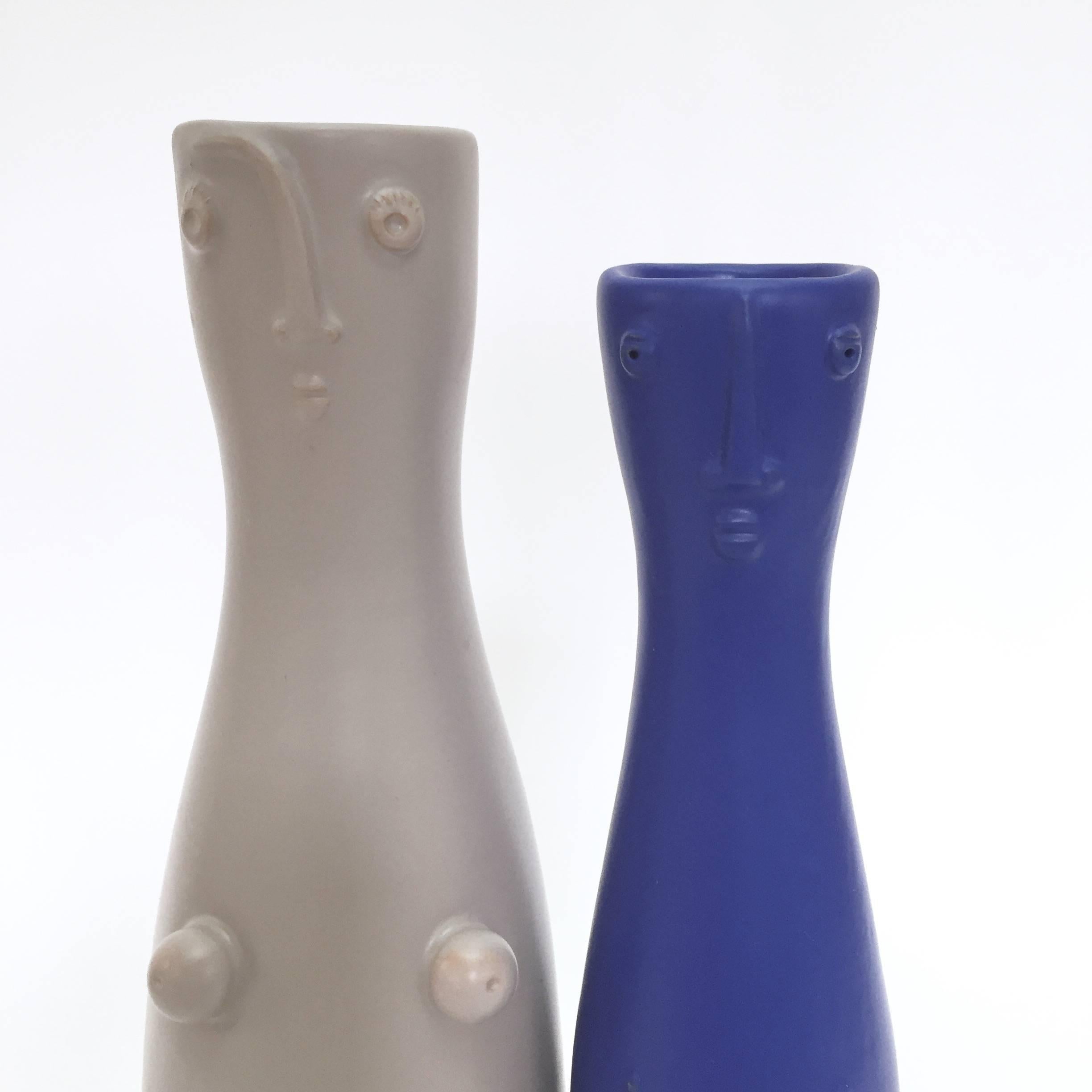 Pair of bottle-vases, organic and figurative shaped, ceramic glazed in pale grey and klein blue, decorated with stylized and naked male and female characters in front.

One of kind handmade pieces, signed by the French ceramicists, the