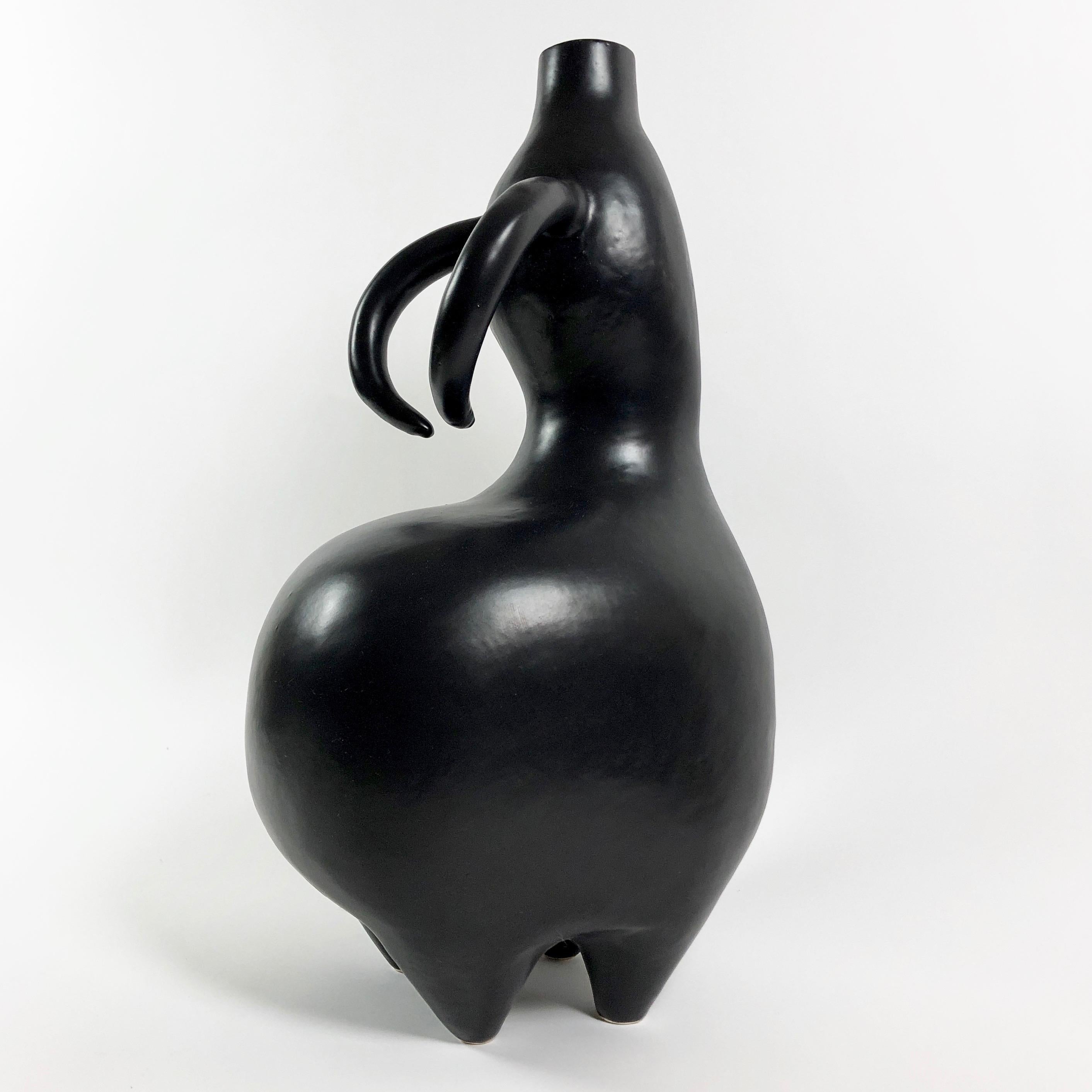 Zoomorphic sculpture forming a decorative table lamp base, animal with horns and on feet shaped. 
Ceramic glazed in matte black. 
One of a kind handmade piece, signed and numerated by the French artists and ceramicists: Dalo. 

*
