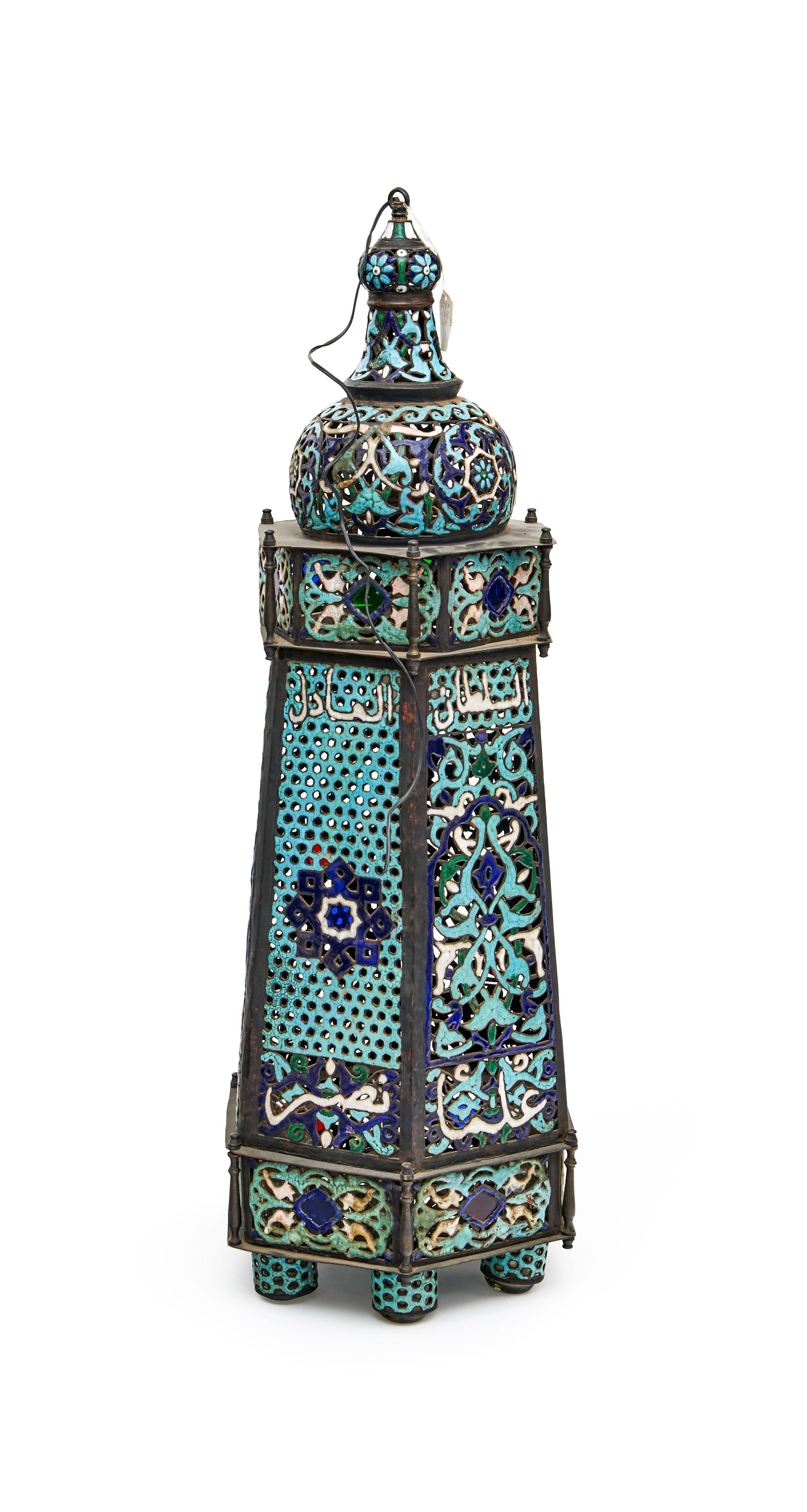 Magnificent mosque lamp made of copper, adorned with exquisite turquoise enamel. This resplendent creation featured six delicate glass candle holders suspended beneath it. The lamp was further enhanced by the inclusion of inscriptions of prayers and
