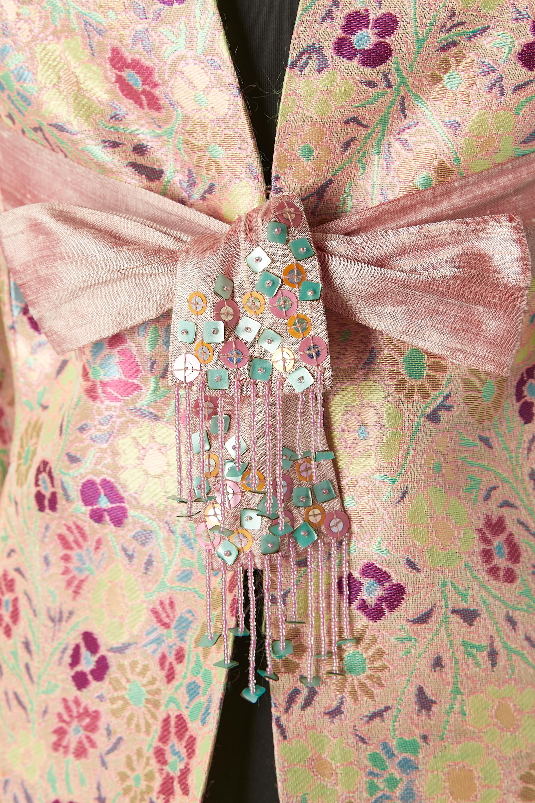 Damask evening jacket with raw silk bow and beads fringes; Main fabric composition: 48% acetate, 40% rayon, 12% silk. Raw silk Half-belt bow in the middle front on the waist. Printed polyester lining. 
Raglan sleeve. Pockets on both side. Hook and