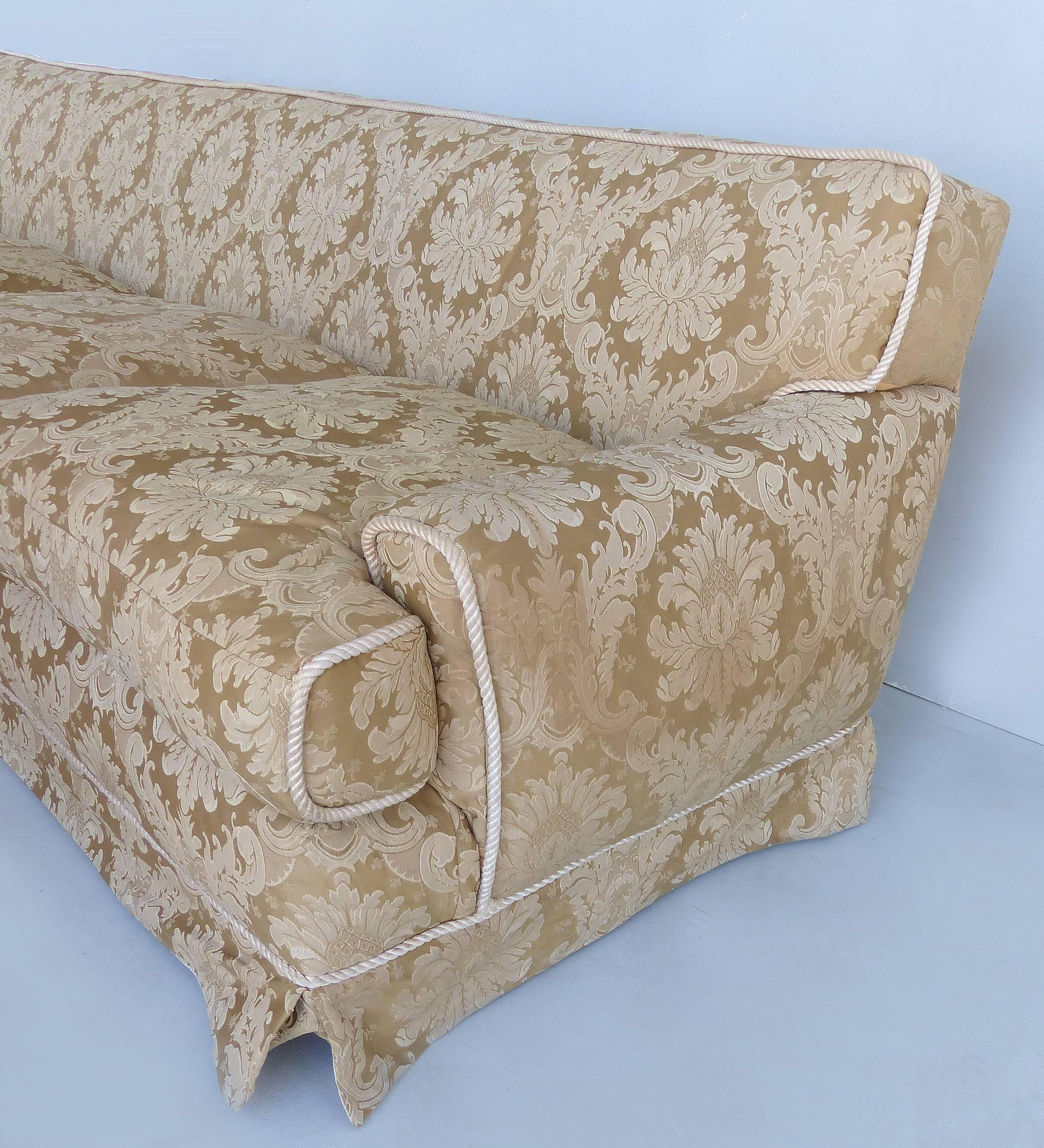 Damask Upholstered Plush Sofa with Rope Trim and Pleated Skirt

Offered for sale is a luxurious damask upholstered sofa with four loose seat cushions, elegant rope trimming, and pleated skirt bottom. Deep, comfortable seats with lush details make
