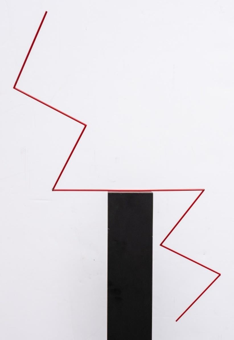 George D'Amato postmodern abstract sculpture, the black-veneered square shaft surrounded by a red-enameled metal lightning bolt, above a white-veneered base. Measures: 38