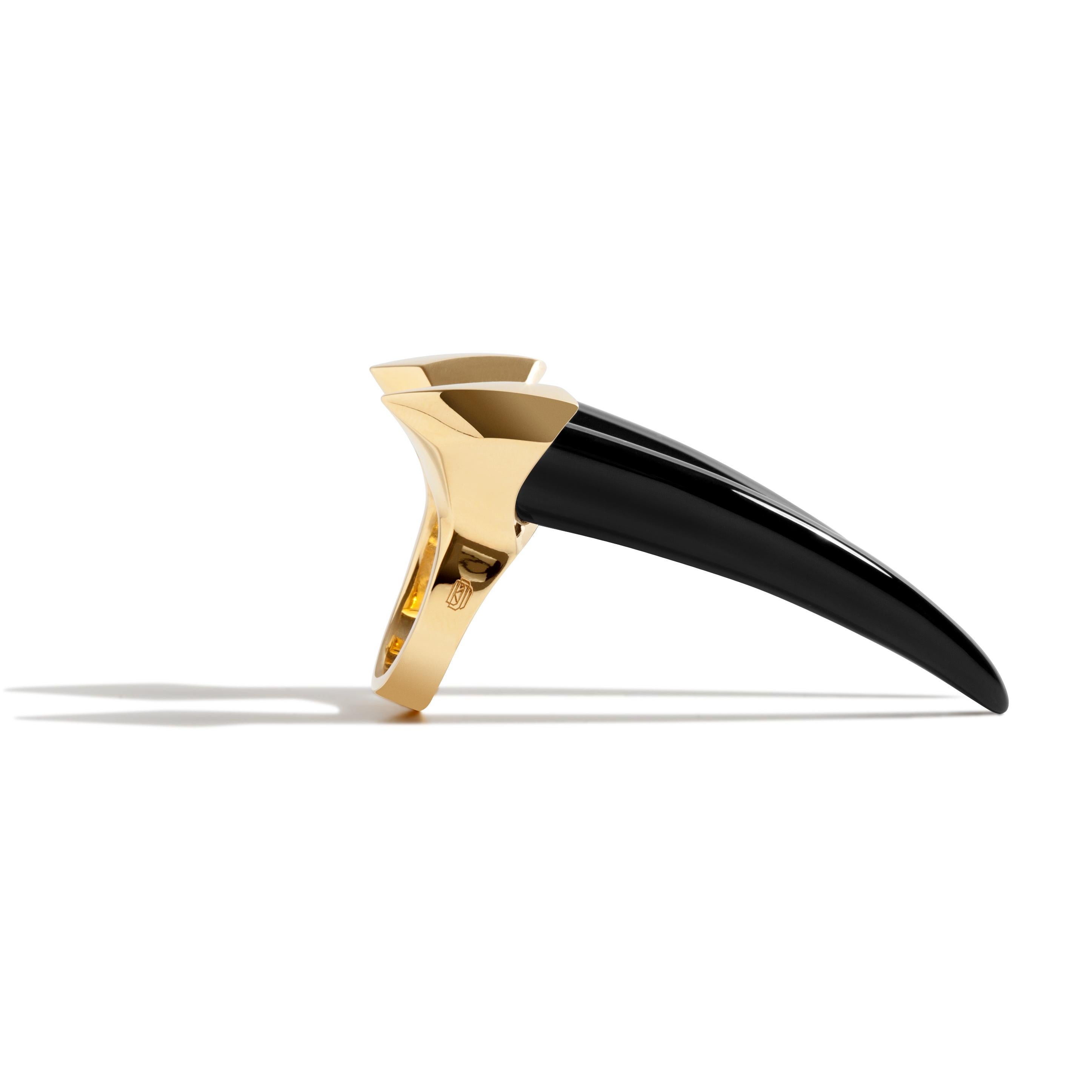 The Damian Onyx Horn Ring by Angie Marei luxuriously crafted in 18-karat yellow gold and hand-carved black onyx is the ultimate must-have statement piece. The powerful yet sensual sculptural design inspired by amulets and talismans worn by the