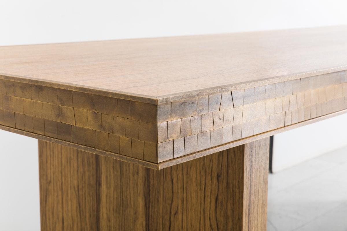 Damian Jones’s Polstead Table employs the artist’s penchant for bold forms with meticulous detailing. Using black limba, an African wood known for its vigorous streaks and veins, Jones has brushed the surface to raise the grain, emphasizing its
