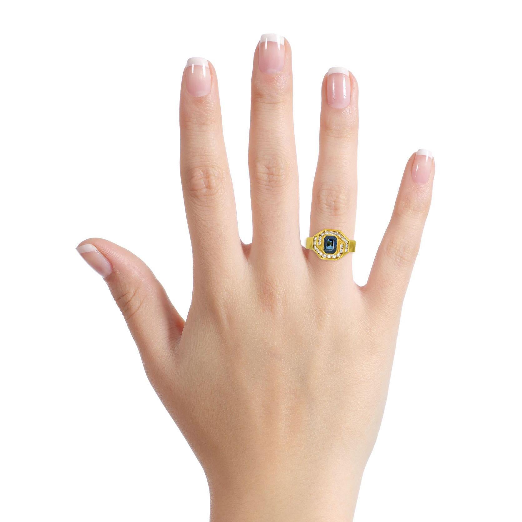 Damiani sapphire and diamond cocktail ring in 18-karat yellow gold. Polished metal setting bezel set with an emerald cut blue sapphire, and numerous round cut diamonds. Made in Italy. 

Size, 7
Height, 6mm
Width, 11.5mm
Depth, 1.5mm
Weight, 7