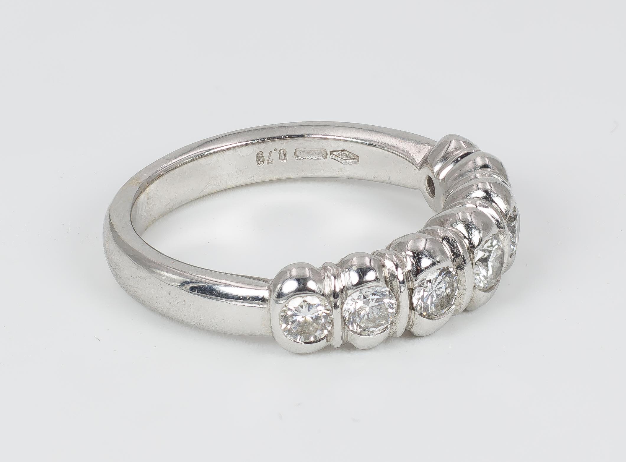 A spectacular vintage Damiani ring, crafted in 18K white gold throughout and set with seven round cut diamonds, totalling 0.75ct ca. The diamonds are placed in a curved gold mount, that gives to the ring a nice shape. 

MATERIALS
18K white gold and