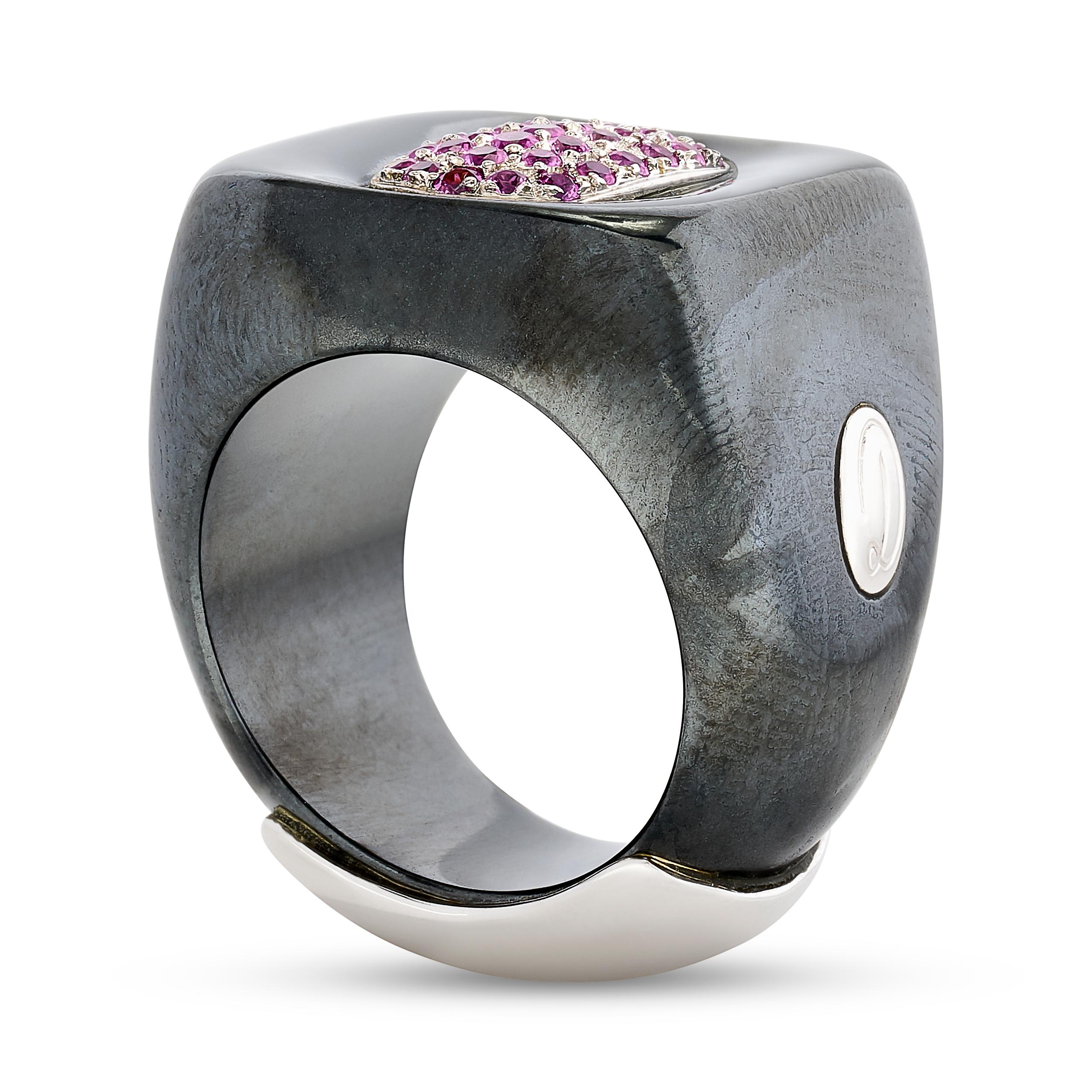 A Damiani ring featuring radiant pink sapphires in a pave center, encased by a wide hematite band.

There are 34 round pink sapphires that weigh approximately 0.65 carats; they are set in 18k white gold.
The ring is a size US 8.
It is stamped: 