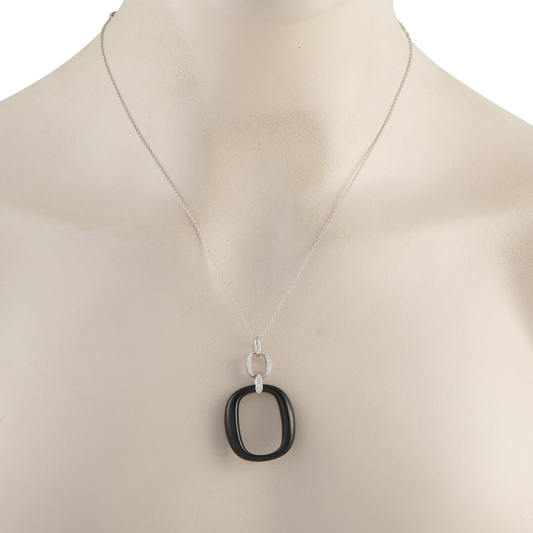 A minimalist design gives this Damiani necklace a contemporary point of view. Suspended from a 19.5 chain, the dramatic pendant pairs black Onyx with sparkling inset Diamonds. The pendant is crafted from 18K White Gold and measures measuring 1.75