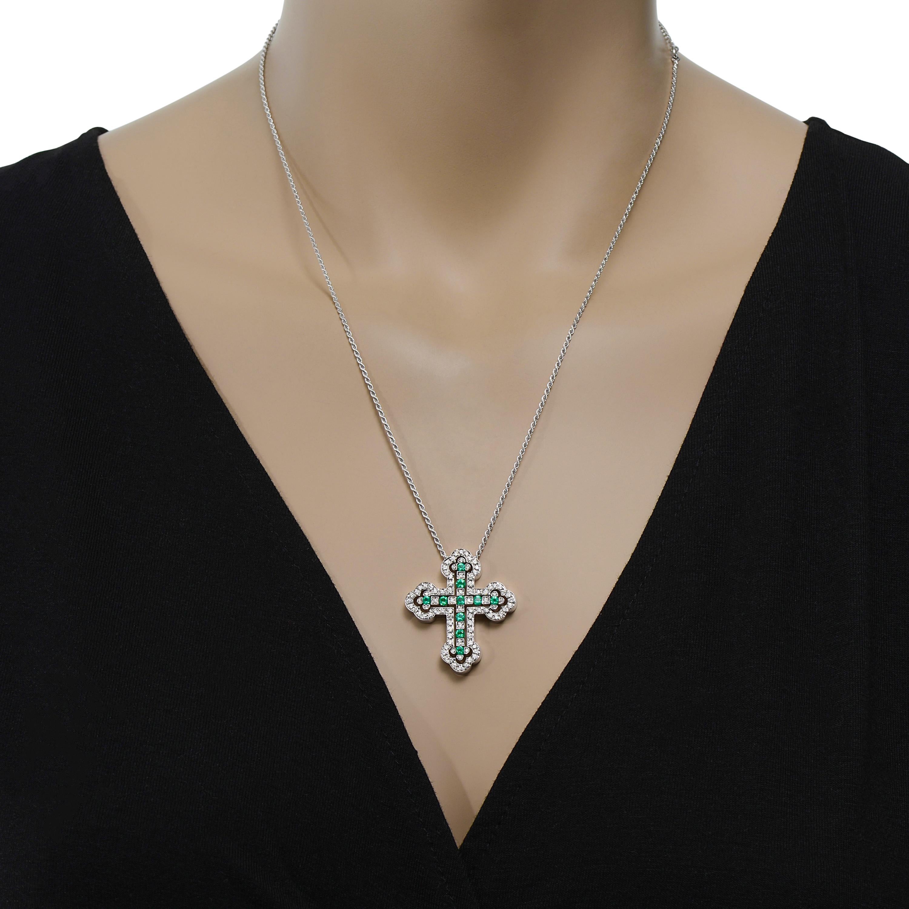 Damiani 18K white gold pendant necklace features 0.52ct. tw. diamonds with 0.50ct. tw. emerald in a delicate cross that comes apart into two pieces. The length is adjustable at 16