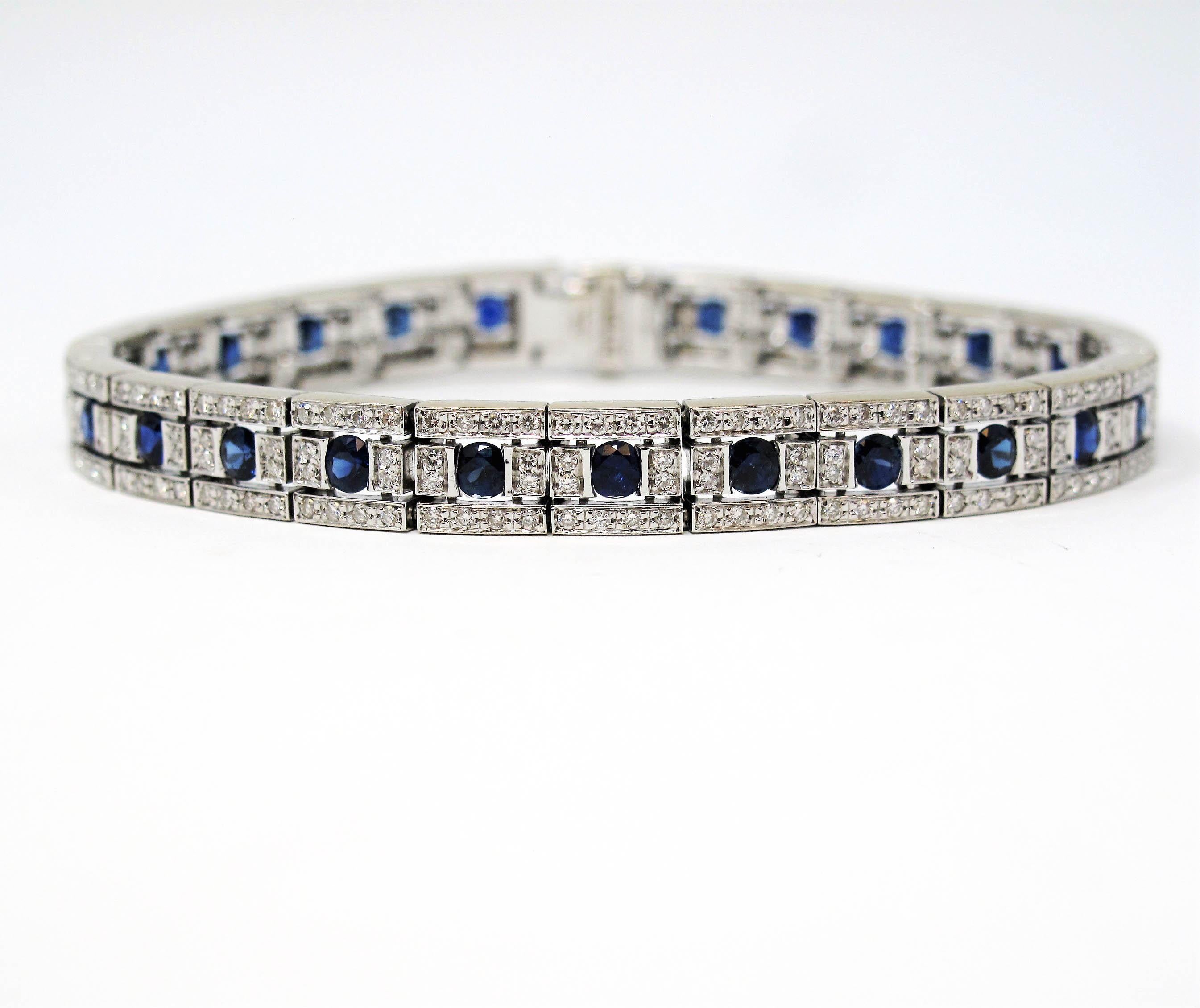 This gorgeous tennis bracelet features 26 round cut sapphire stones set along the center of the bracelet. The sapphires are a rich, deep blue color and total 3.45 carats. Bordering the edges of the bracelet, as well as in between each sapphire