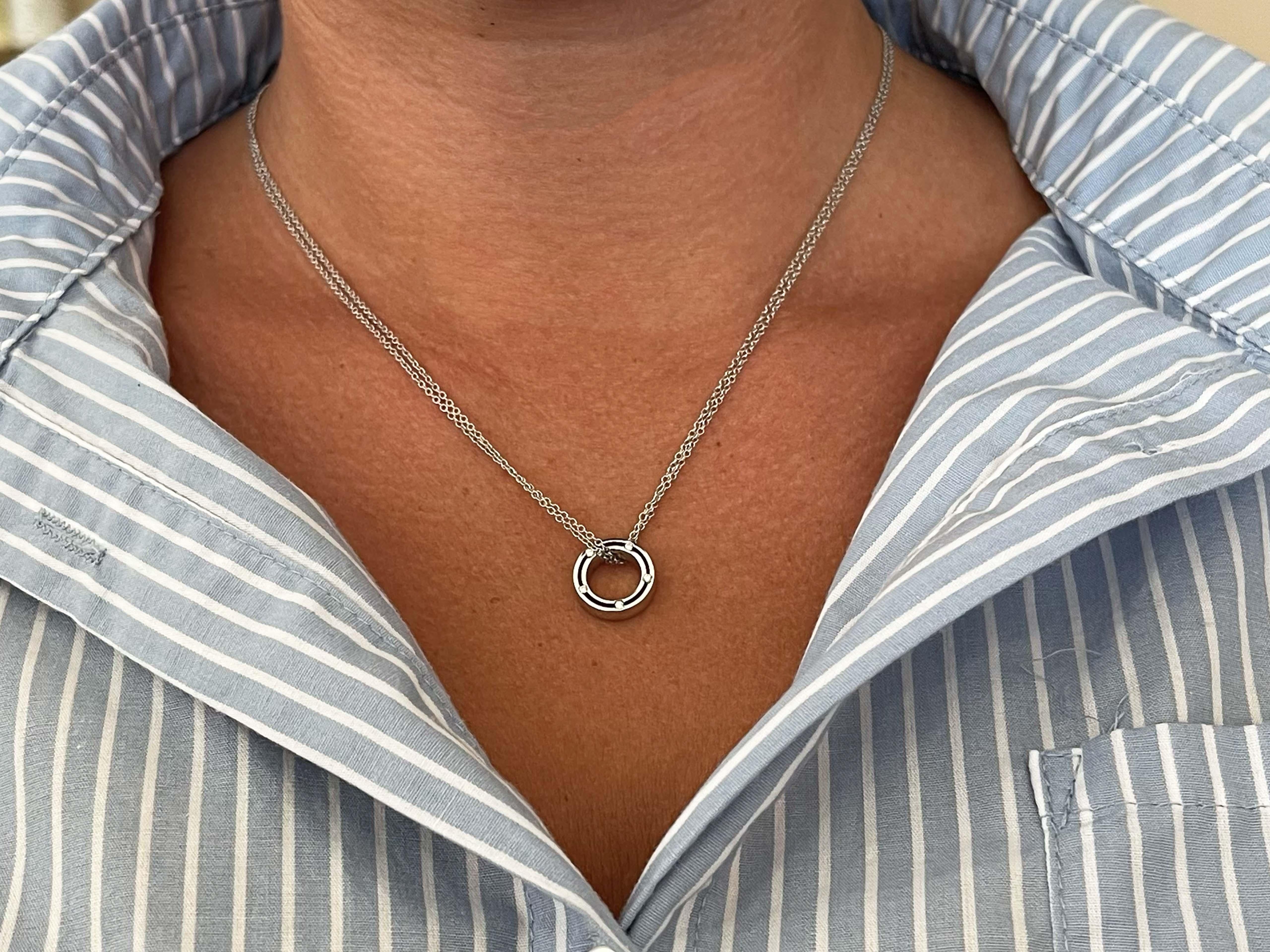 Damiani and Brad Pitt Designed 18K White Gold and Diamond Circle Necklace. A contemporary 14K white gold and diamond circle necklace co-designed by Damiani and Brad Pitt. A delicate double cable link chain suspends a circle pendant having five