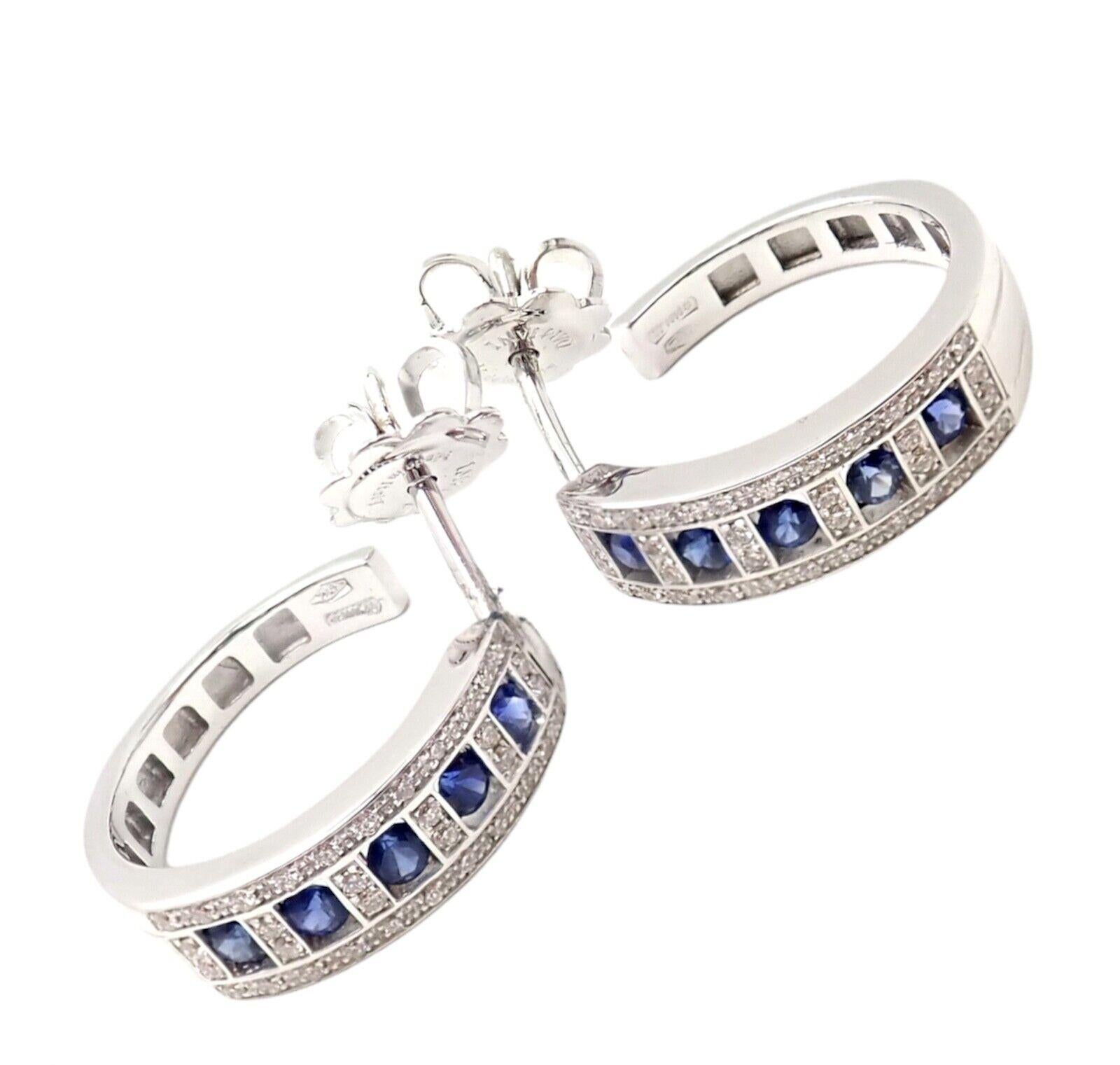 18k White Gold Diamond And Sapphire Hoop Earrings by Damiani.  
With 36 round old brilliant cut diamond E-G color, VS-SI clarity total weight approx. .35ctw
10 round brilliant cut sapphires  
These earrings come with original box and paper.
Details: