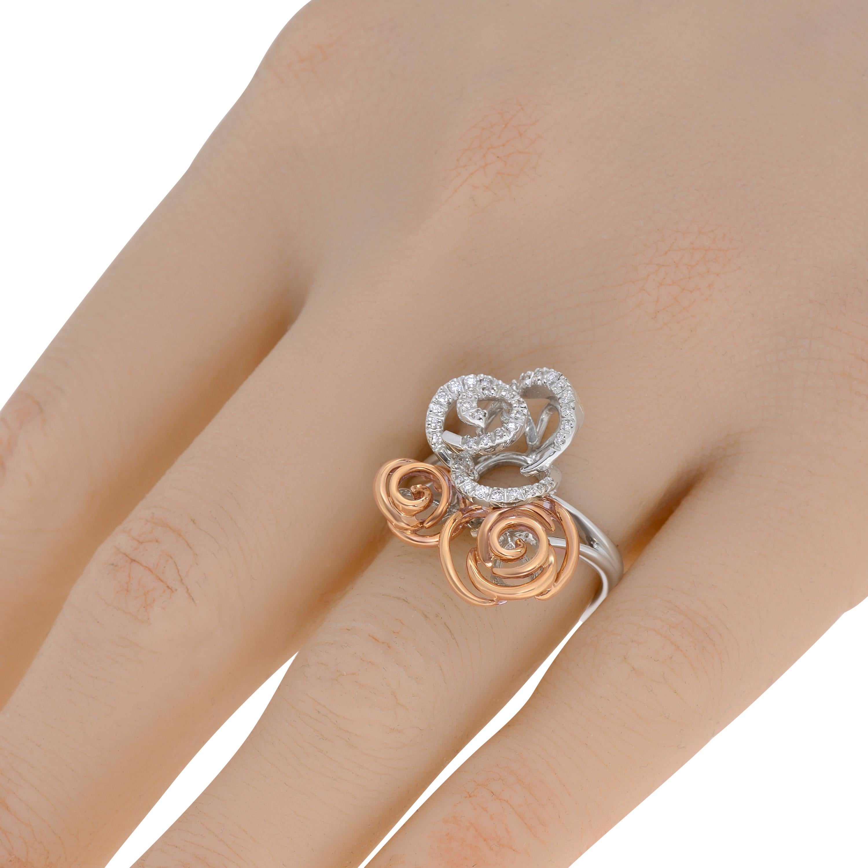 Damiani 18K white and rose gold ring features 0.19ct. tw. bar set diamonds in a two tone rose design. The ring size is 7.25 (55.1). The decoration size is 3/4