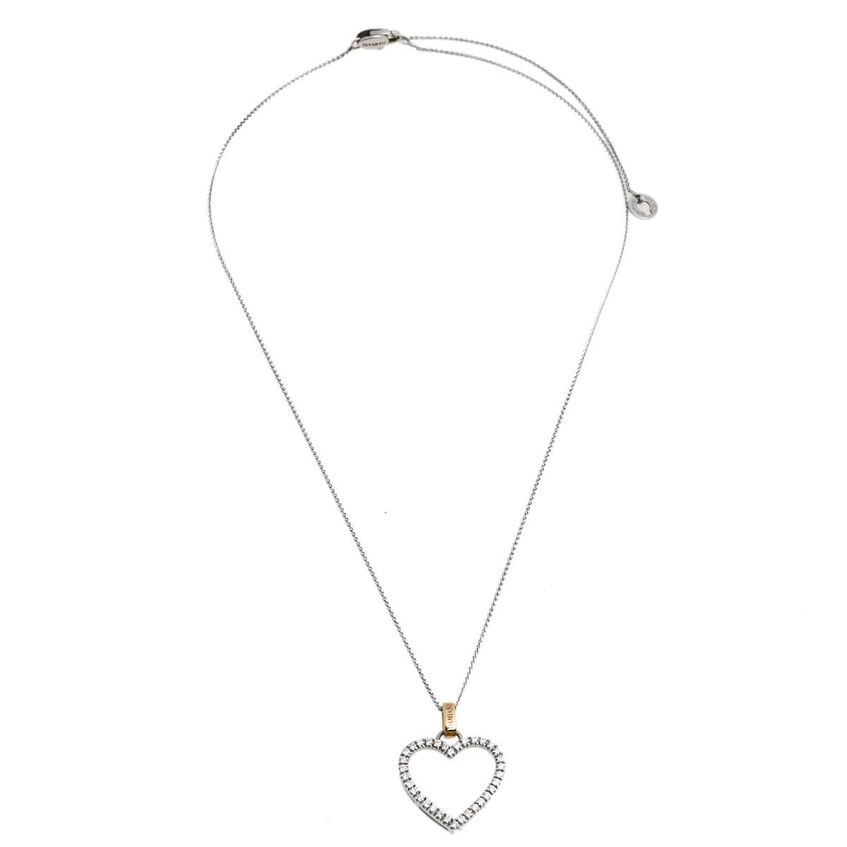 This necklace from Damiani exemplifies minimal style with modern aesthetics. It is made from 18k white gold and the chain holds a gorgeous heart-shaped pendant decorated with diamonds. The bail is rendered in yellow gold and is engraved with the