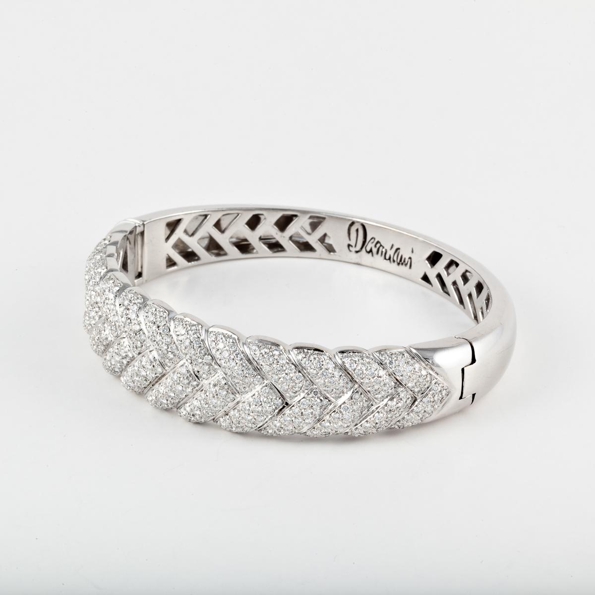 Damiani hinged bangle bracelet in 18K white gold with pavé round diamonds.  The bracelet is marked 