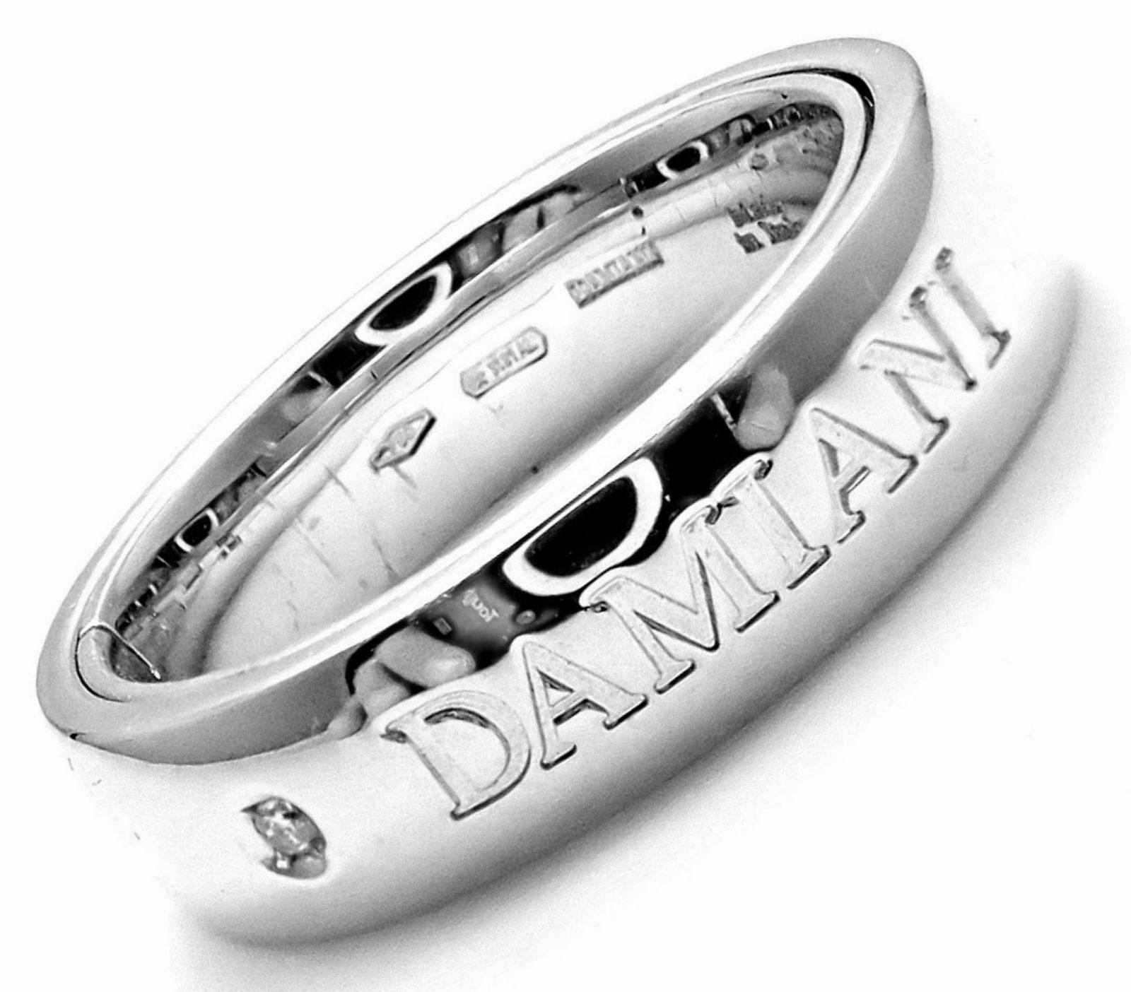 18k White Gold Diamond Double Band Ring by Damiani.
With 2 round old European cut diamond E-G color, VS-SI clarity total weight approx. .05ct on inside of the band.
This ring comes with Damiani Box + Paperwork.
Details:
Size:  7
Weight: 11