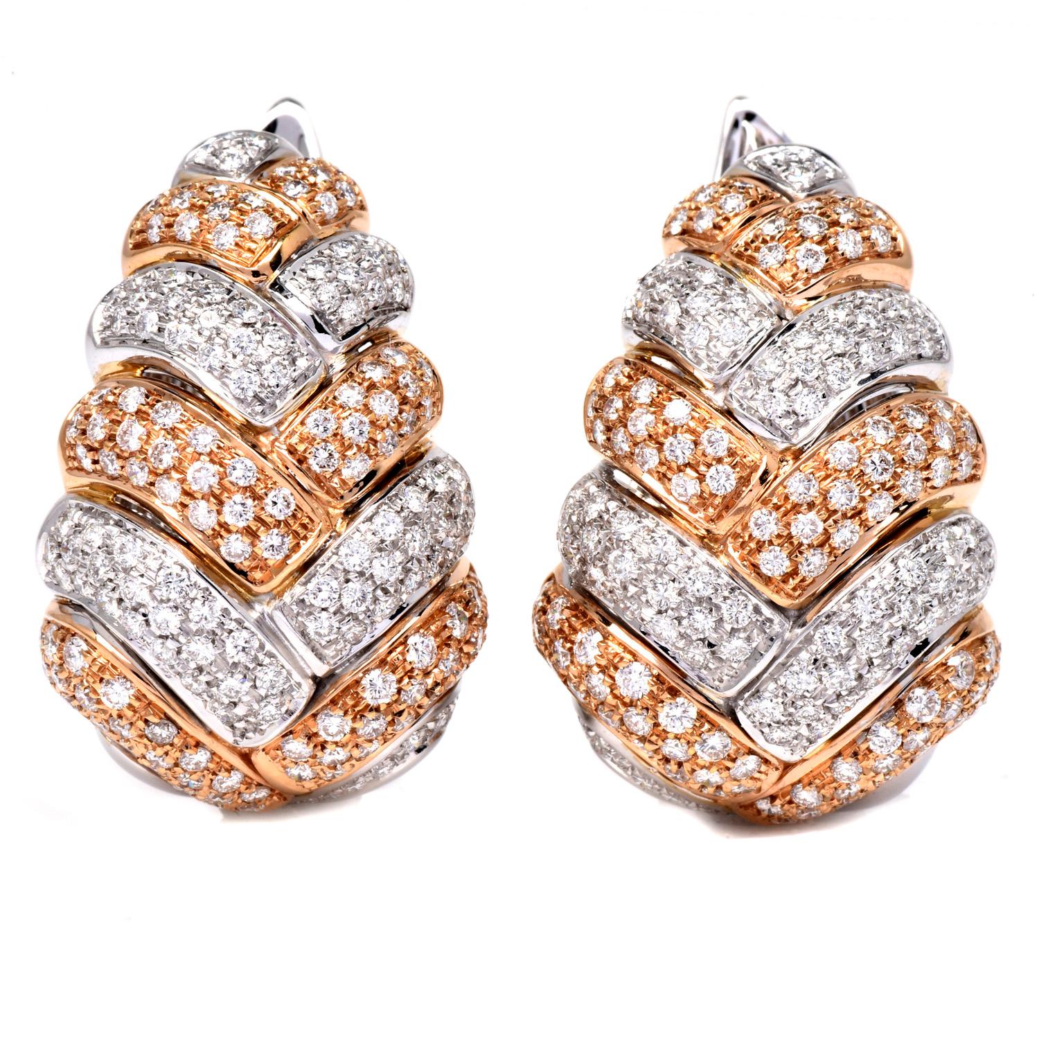 These Damiani earrings were created 1n 18k white and rose gold

inspired by a shell motif. Exclusively hand Crafted in 18K white gold by Damiani,

these hoop earrings measure approx. 27mm x 13mm long.  

waves of vibrant white diamonds cascade