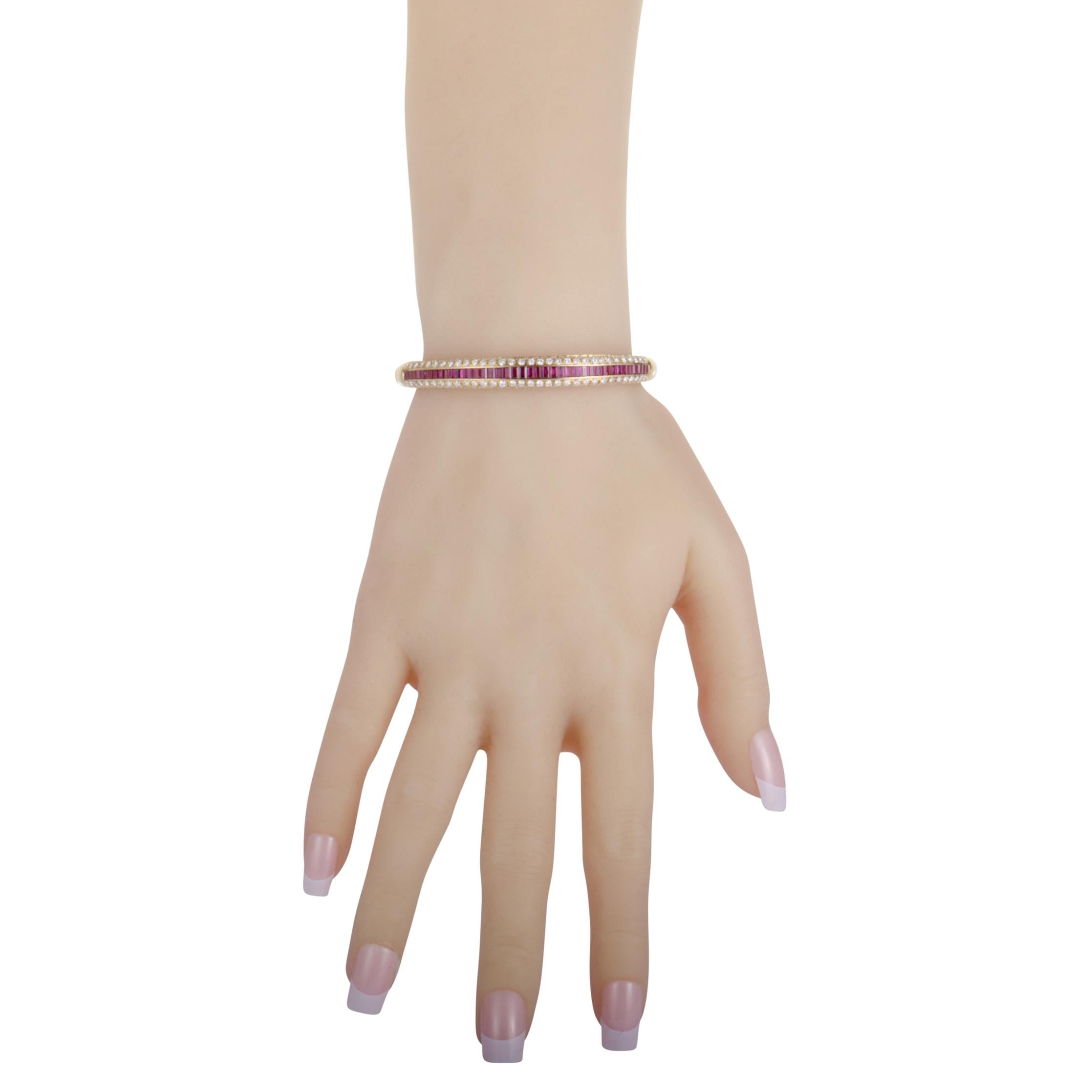 Exquisitely crafted from luxurious 18K yellow gold and beautifully decorated with a plethora of attractive gems, this sublime Damiani bangle boasts a splendidly elegant appeal. The bangle is set with rubies that weigh approximately 2.75 carats in