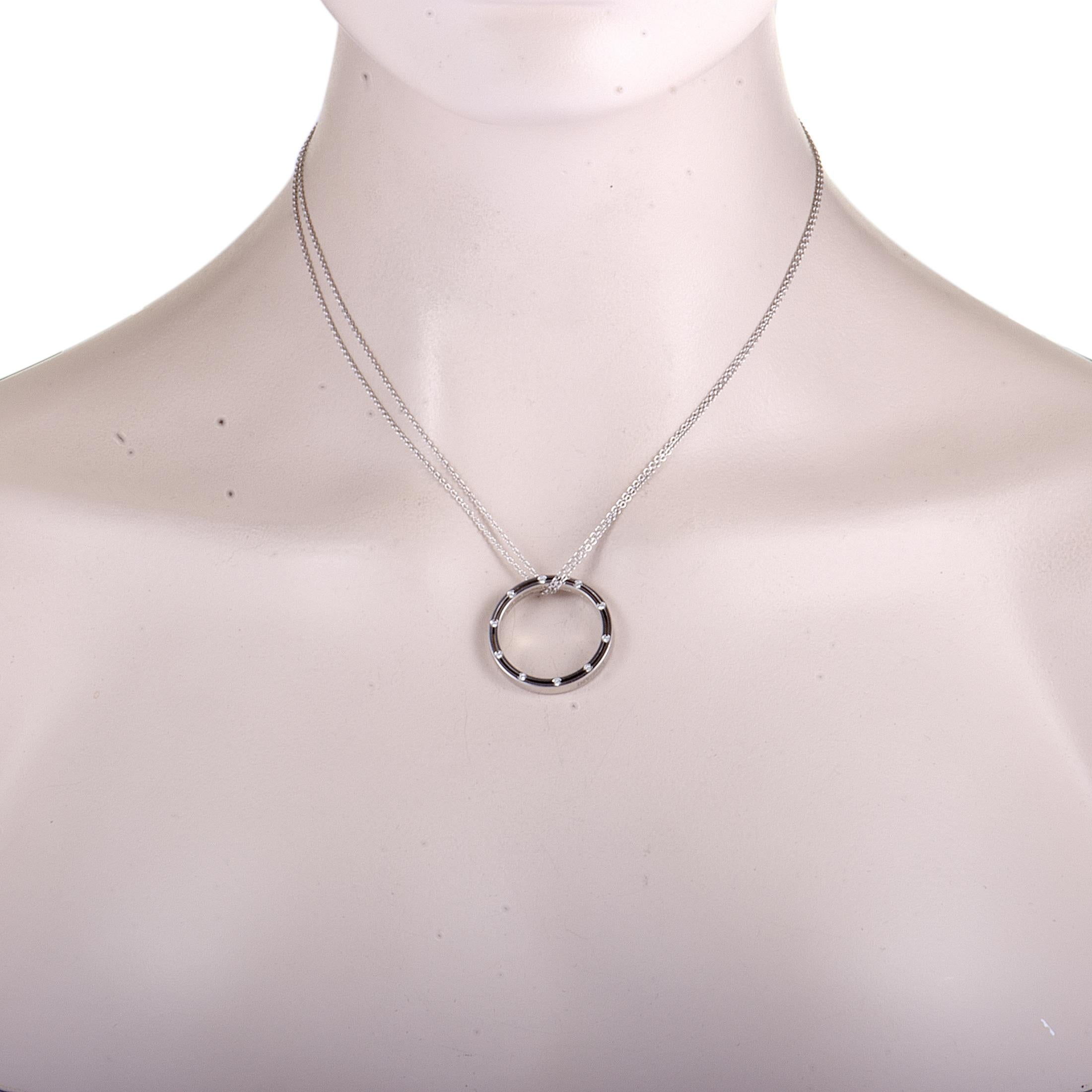 This stunning necklace by Damiani is a compelling illustration of elegance! Exquisitely designed in shimmering 18K white gold, its attractive hoop pendant is embellished with 0.18ct of scintillating diamonds that enhance the beauty of the