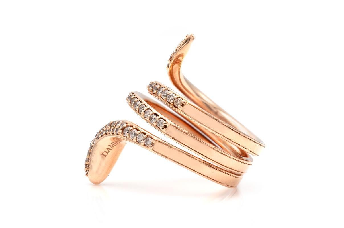 Finely crafted 18k rose gold with Round Brilliant cut Diamonds weighing a total of 0.96 carat.
Signed by Damiani
Made in Italy
Size 6 1/2
