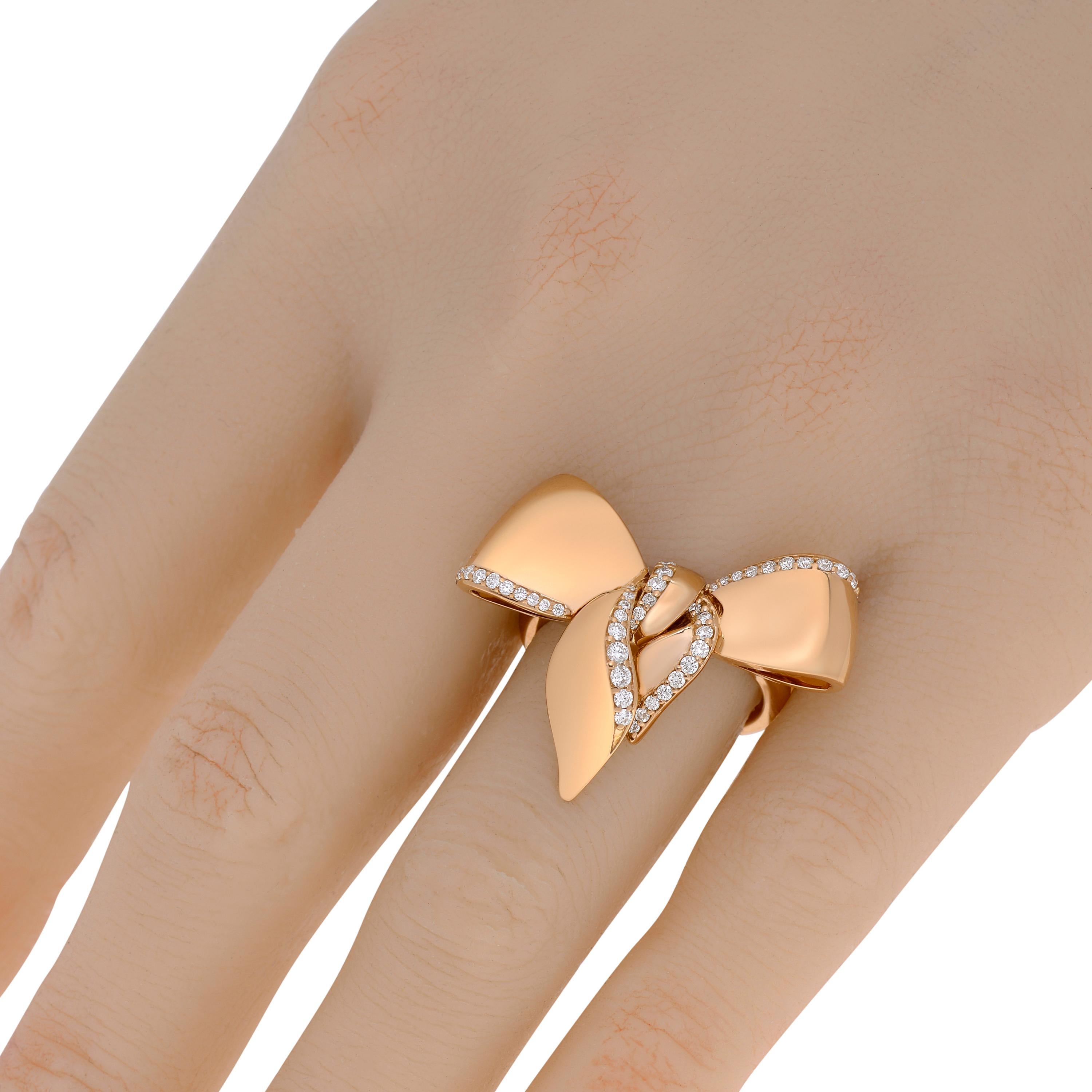 Damiani ring features 0.33ct. tw. diamonds bordering a polished bow in 18K rose gold. The ring size is 7.25 (55.1). The decoration size is 1 1/8