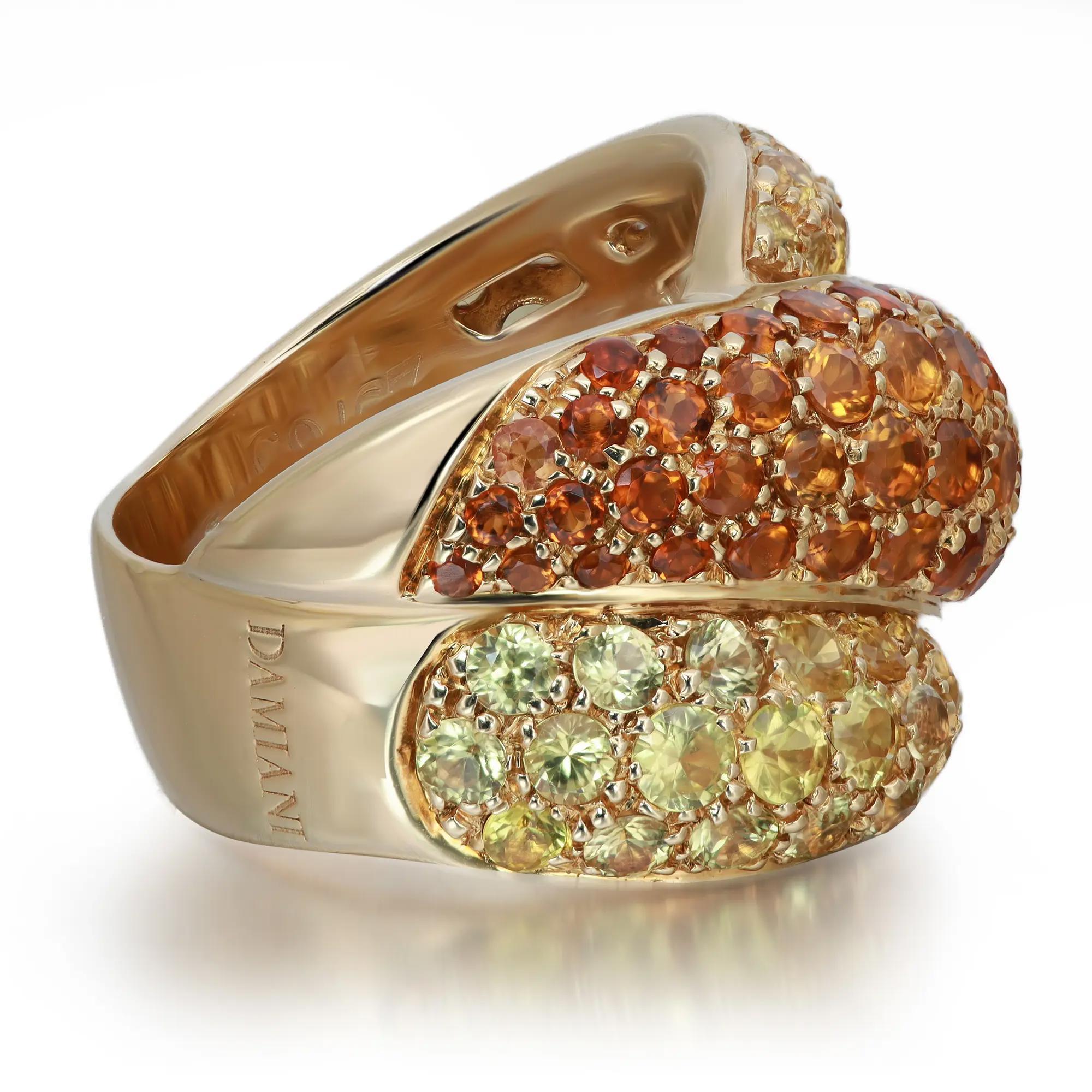 This stunning Damiani cocktail ring from Gomitolo collection comes with a flashy statement look. A must have in your jewelry collection. The ring is crafted in 18K yellow gold. Features pave set round cut yellow sapphires with brown citrine stones