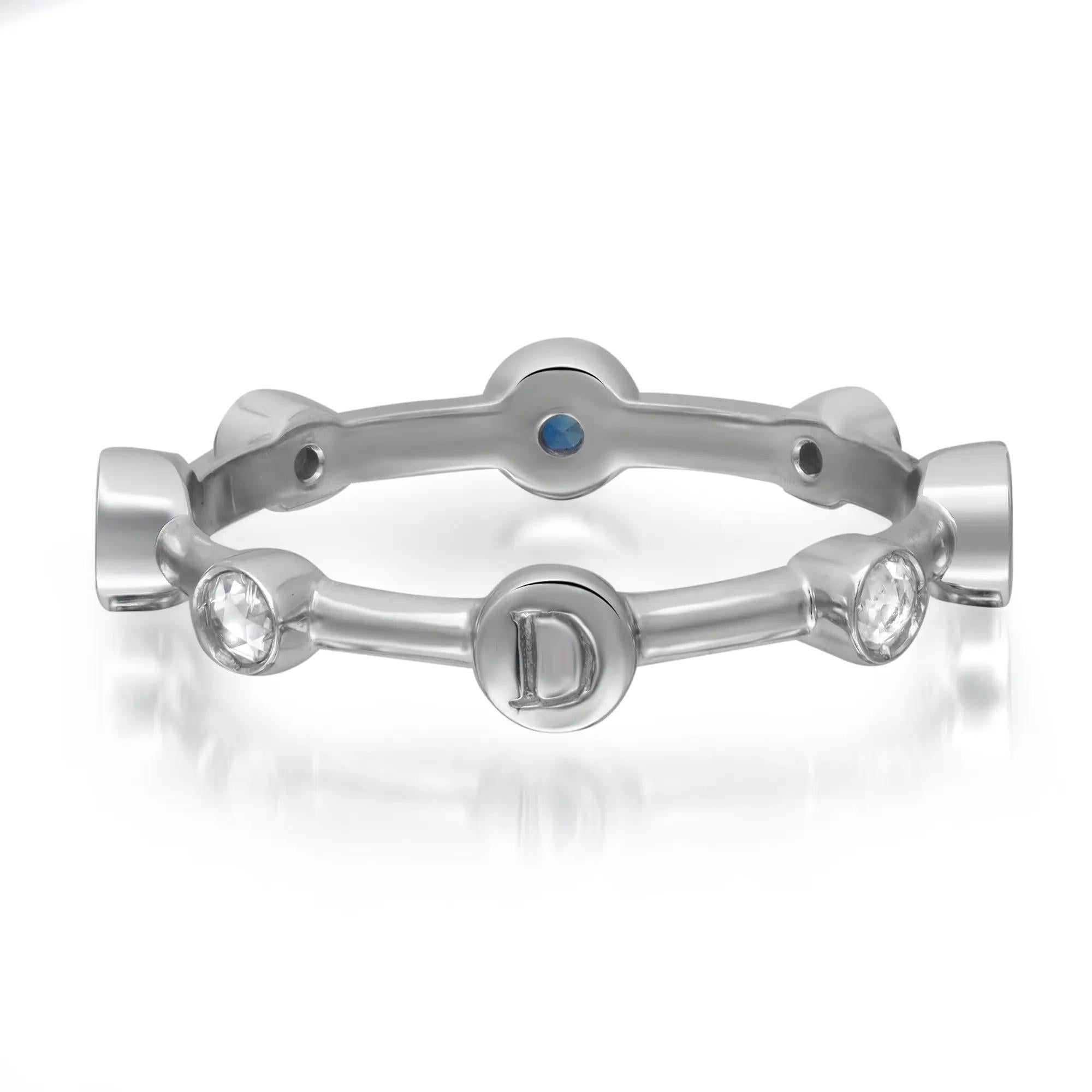 This chic and stylish Damiani Moon Drops ring features round cut sparkling diamonds and blue sapphires in bezel setting. The stones are studded at an equal distance all around the band. Crafted in 18K white gold. Total diamond weight: 0.10 carat.