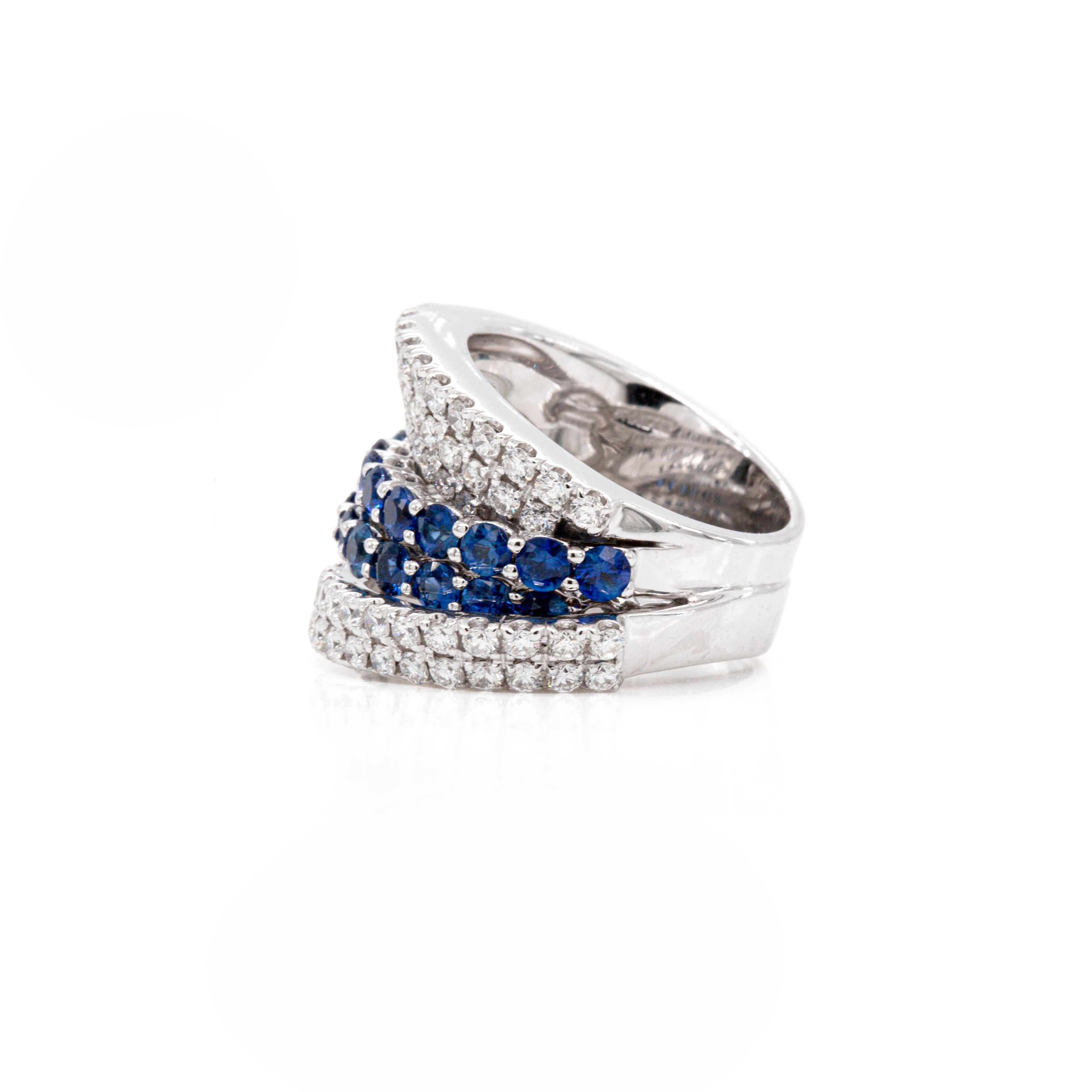 This is an exquisite Italian-made diamond and blue sapphire dress ring by Damiani. 

This gorgeous ring features a striking asymmetric design, masterfully crafted from solid 18 carat white gold. Two rows of stunning Royal Blue sapphires are set