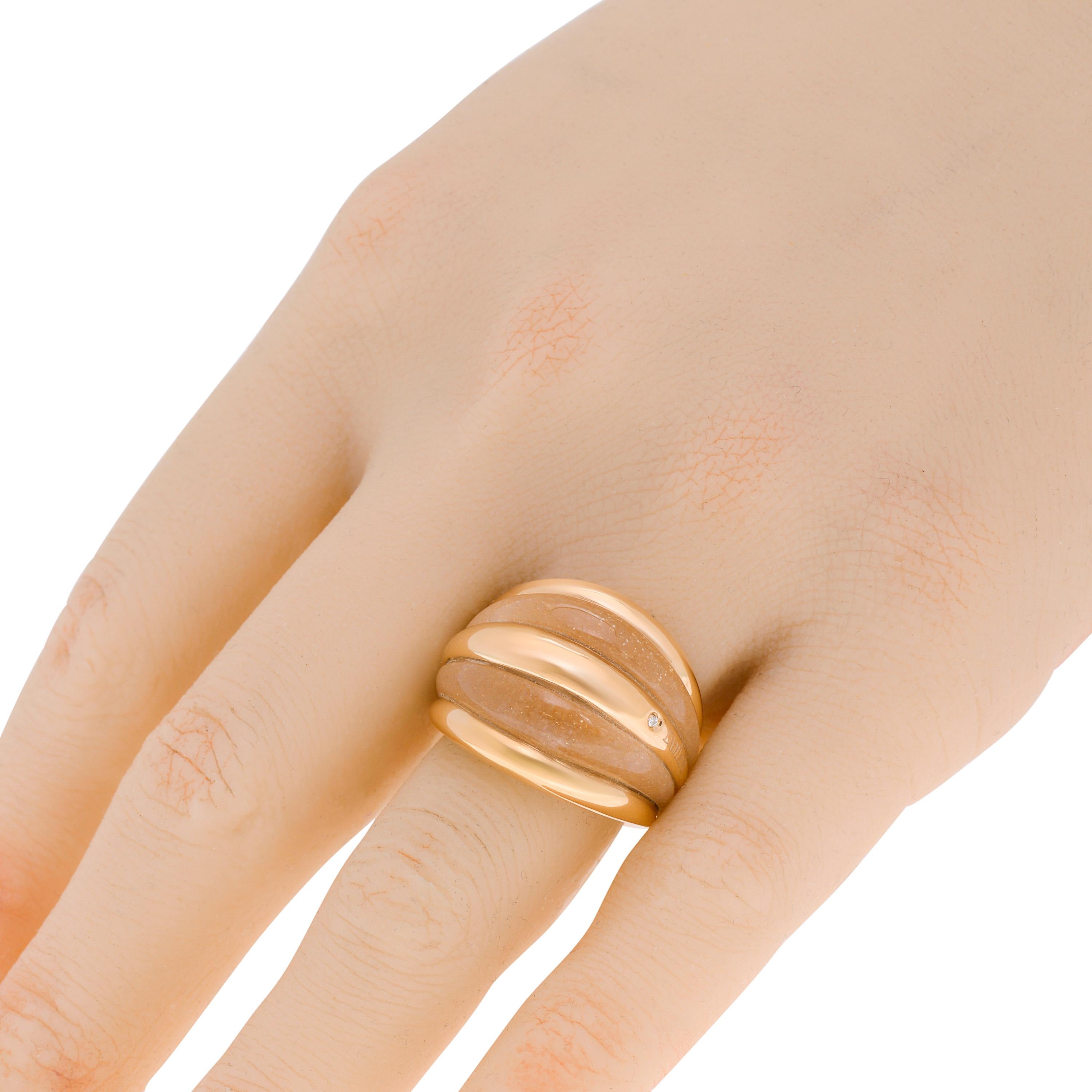 Damiani Dome Ring features tiers of sun stone and polished 18k rose gold with a 0.01ct. tw. diamond accent. The ring size is 5.75 (51.3). The band Width is 6.5mm. The weight is 7.5g.
