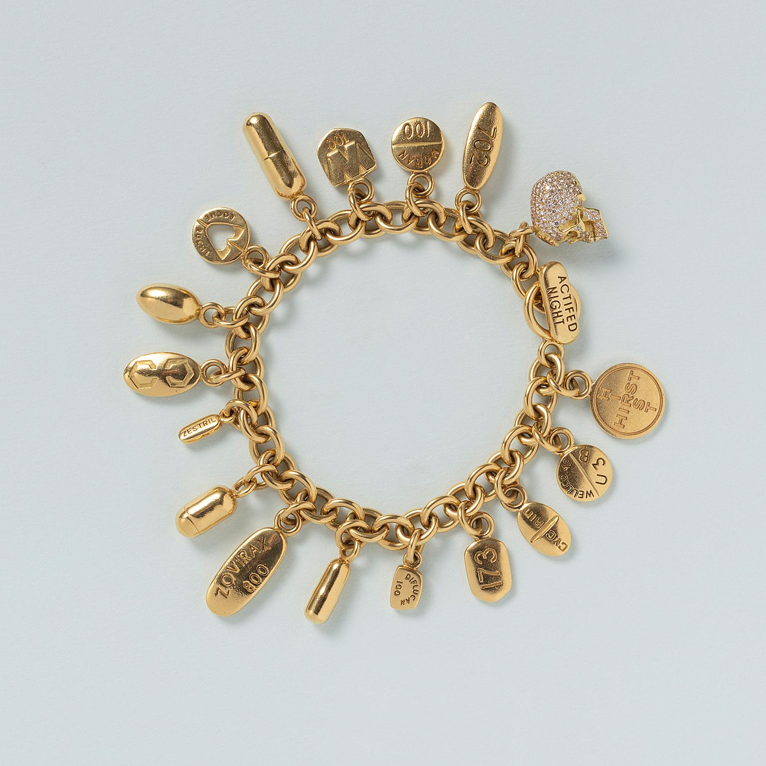 An 18 carat gold charm bracelet with 17 gold pills and one skull pavé set with diamonds, signed and numbered: Damien Hirst, 8/50, with English assay marks on one of the charms, London, 2013, with original case.

This bracelet was inspired by Hirst’s
