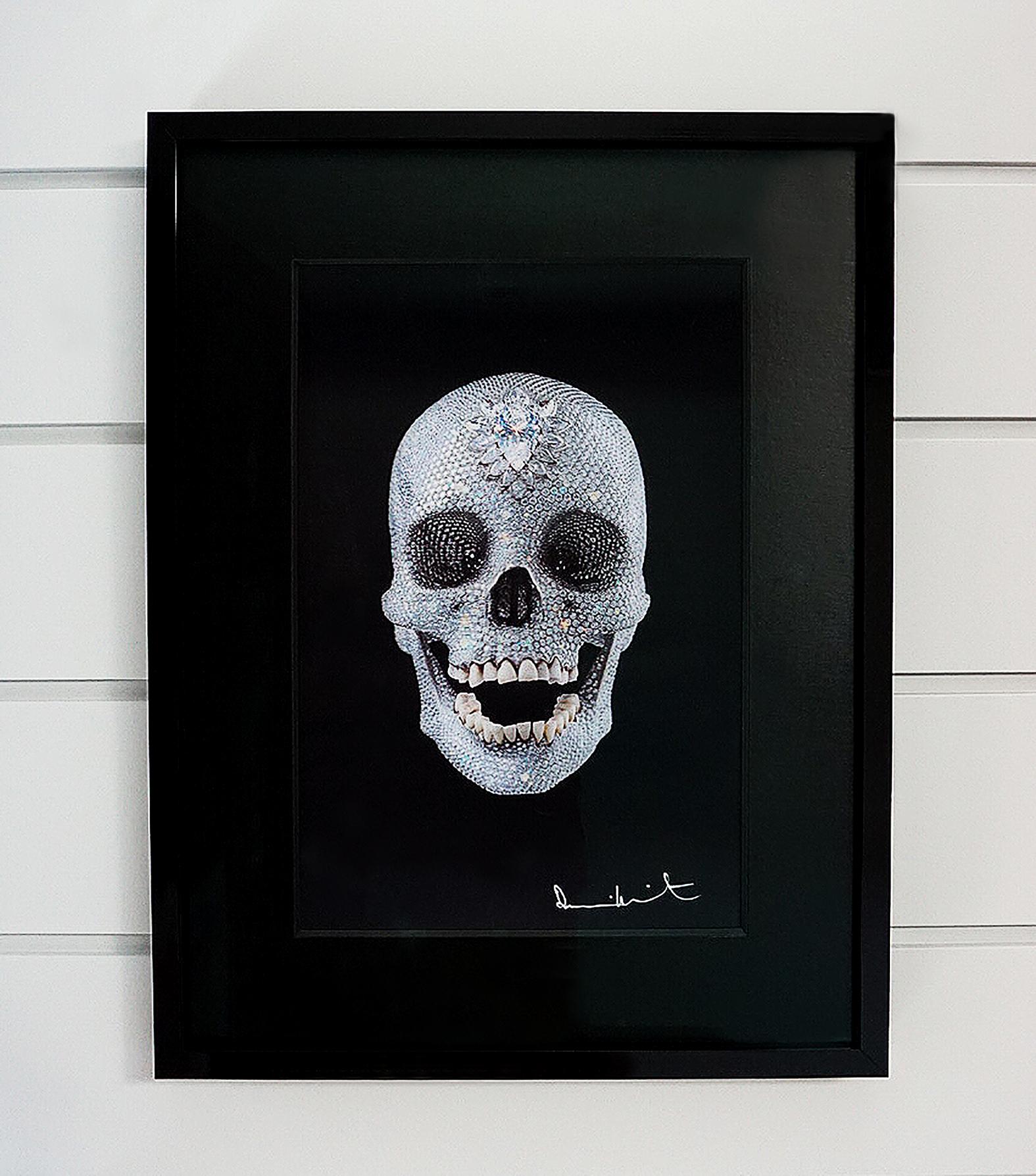 A brilliant lenticular print of a three dimensional Skull created by Damien Hirst, entitled: "For The Love Of God". The artwork comes ready to install in a custom black lacquer frame with complementing black textured matte. The shimmering effects of