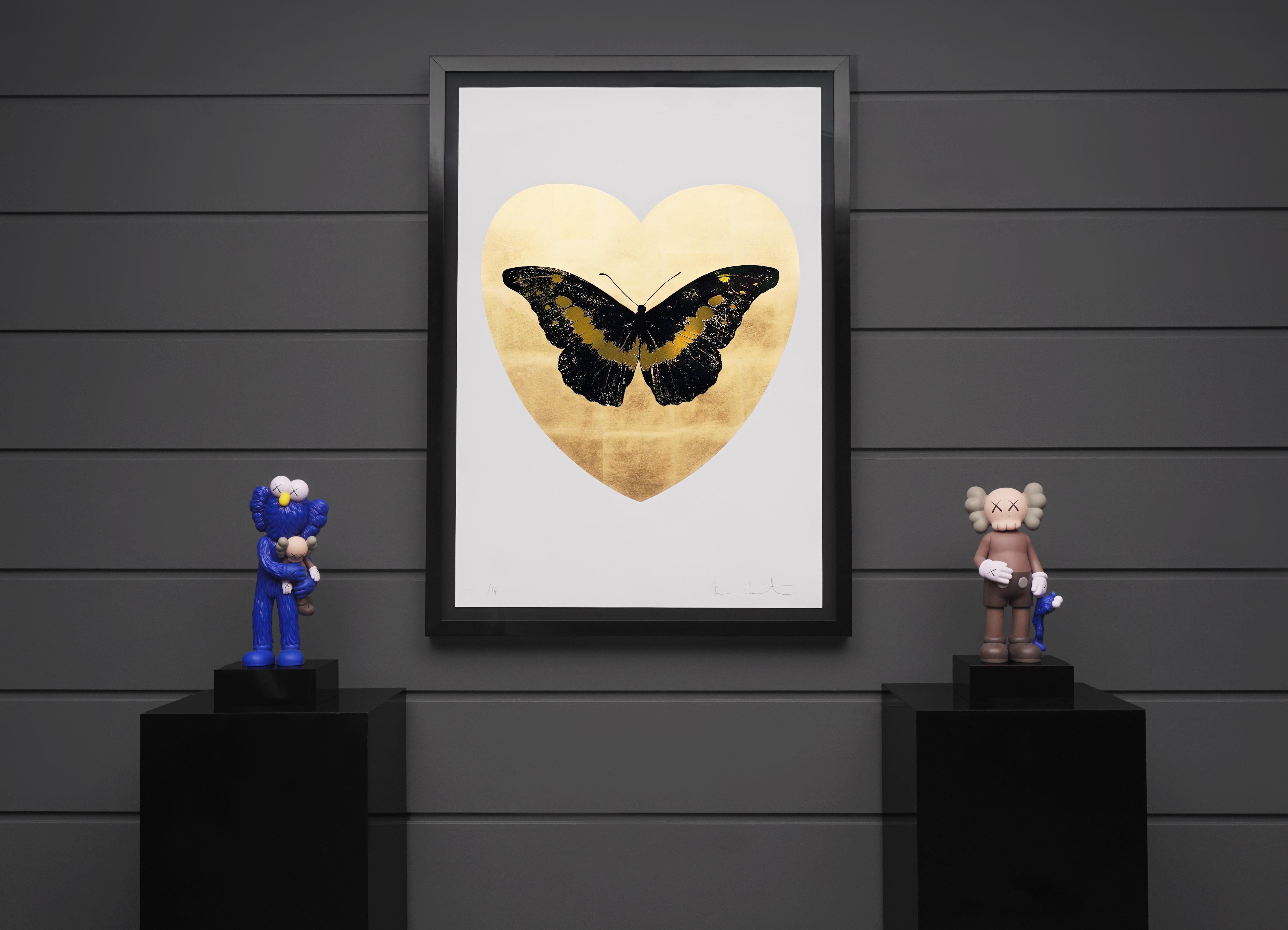 The 'I Love You' Butterfly in Black and Gold is a limited edition silkscreen print by Damien Hirst. This uplifting artwork features a foil-block butterfly, surrounded by a 24K gold leaf heart and set on a white background of Somerset Satin 410gsm