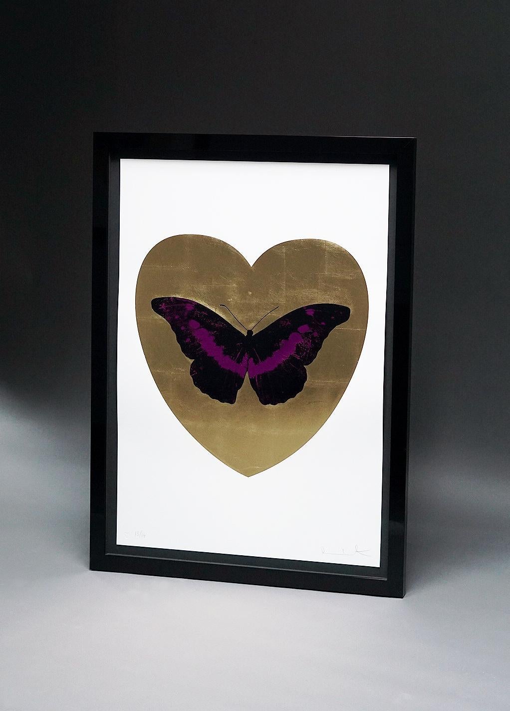 The 'I Love You' Butterfly in Fuchsia and gold color scheme is a limited edition silkscreen print by Damien Hirst. This uplifting and pop art work features a fuchsia and black foil-block butterfly over a gilded 24K gold leaf heart, surrounded by a