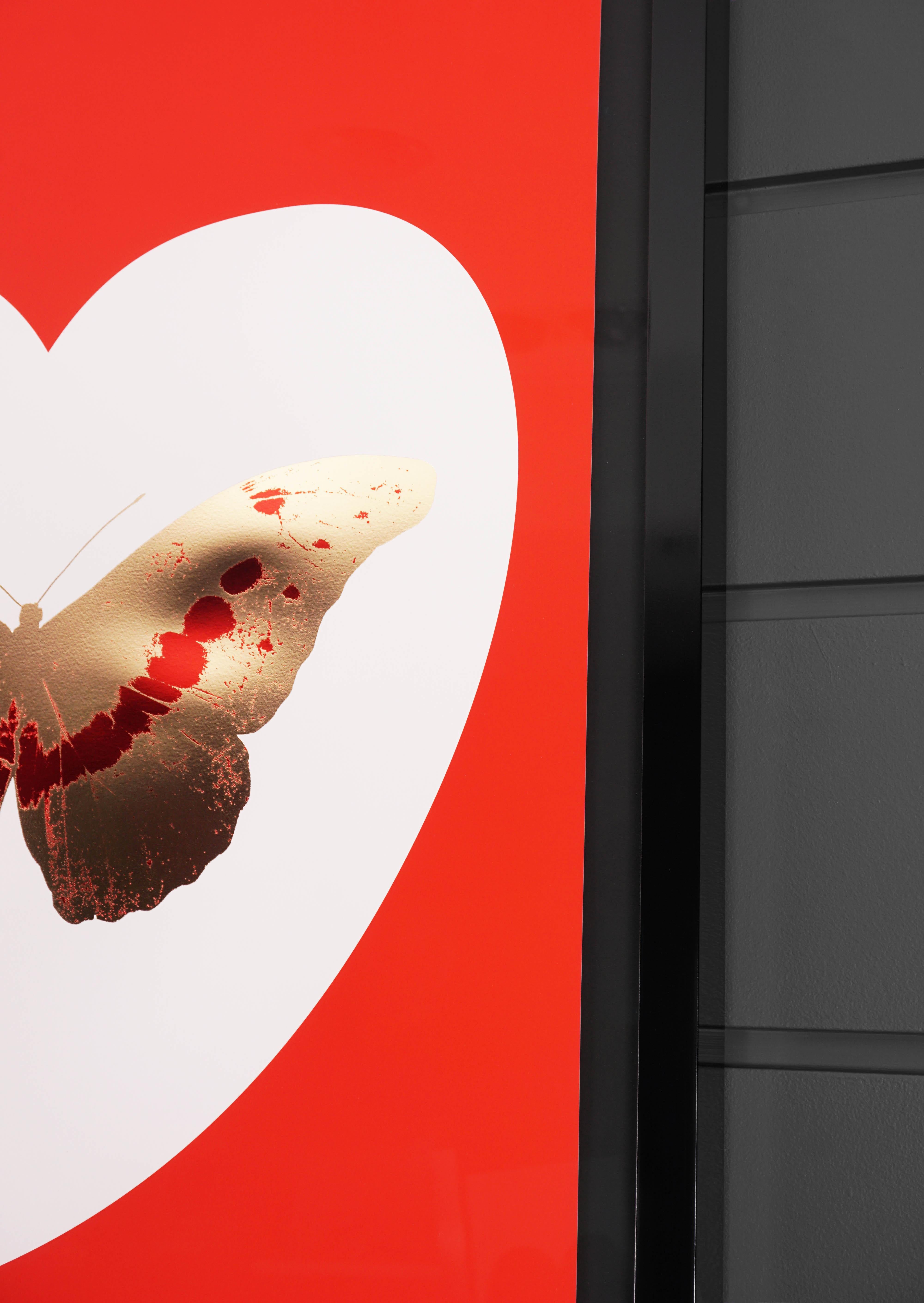 The 'I Love You' Butterfly in bright red and gold color scheme is a limited edition silkscreen print by Damien Hirst. This uplifting and pop art work features a gilded 24K gold leaf butterfly with deep red detailing, surrounded by a white heart and